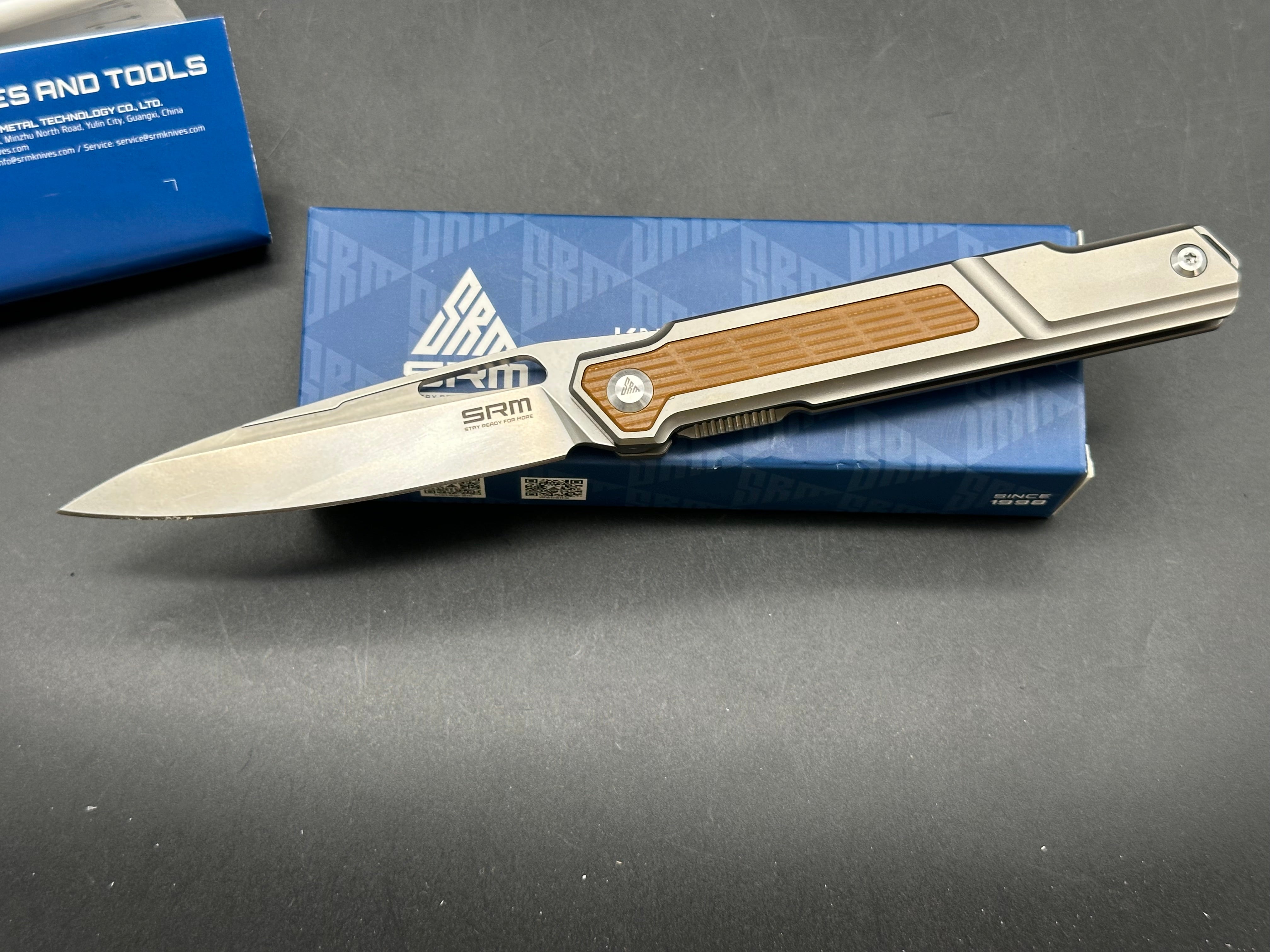 SRM model 1421: 3.63 inch N690 blade. Titanium frame with tan G10 insert