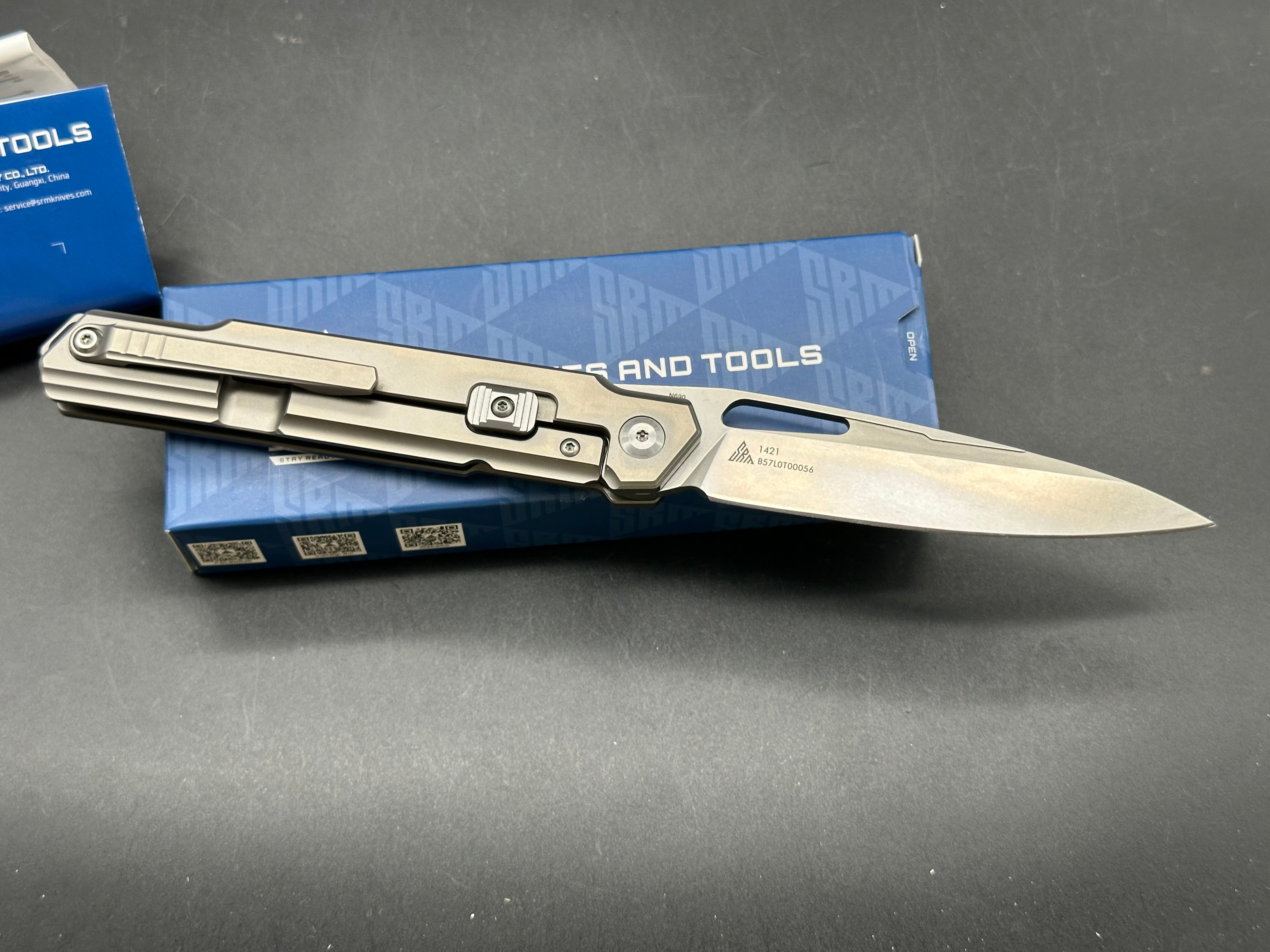 SRM model 1421: 3.63 inch N690 blade. Titanium frame with tan G10 insert