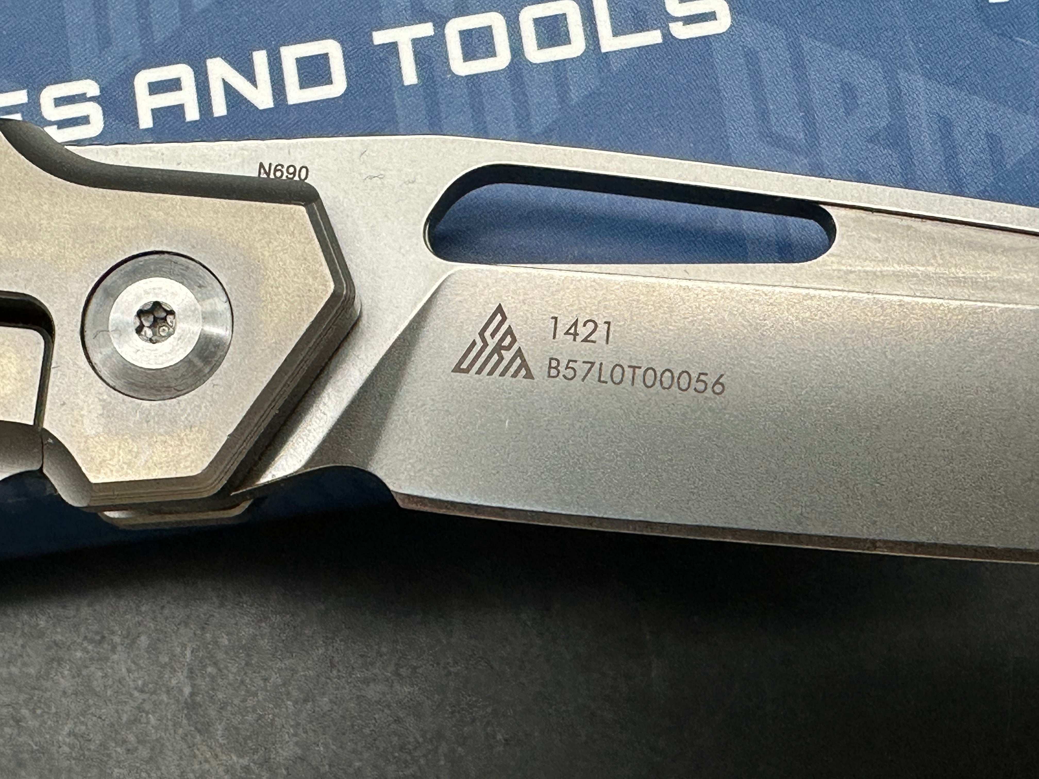 SRM model 1421: 3.63 inch N690 blade. Titanium frame with tan G10 insert