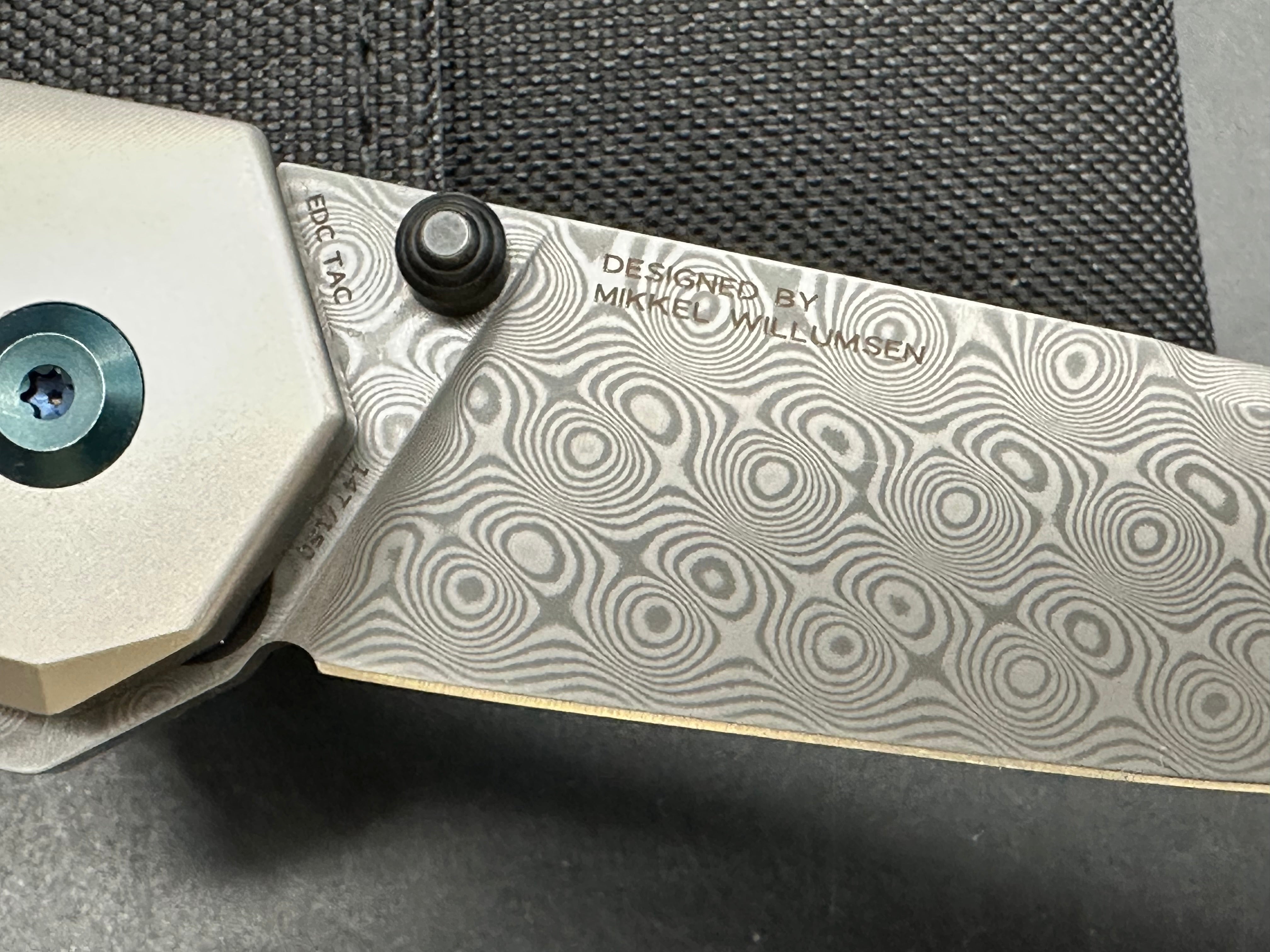 Kansept EDC Tac: Mikkel Willumsen design. 3.1 inch flat grind Damascus blade. Carbon fiber and titanium front and back scales