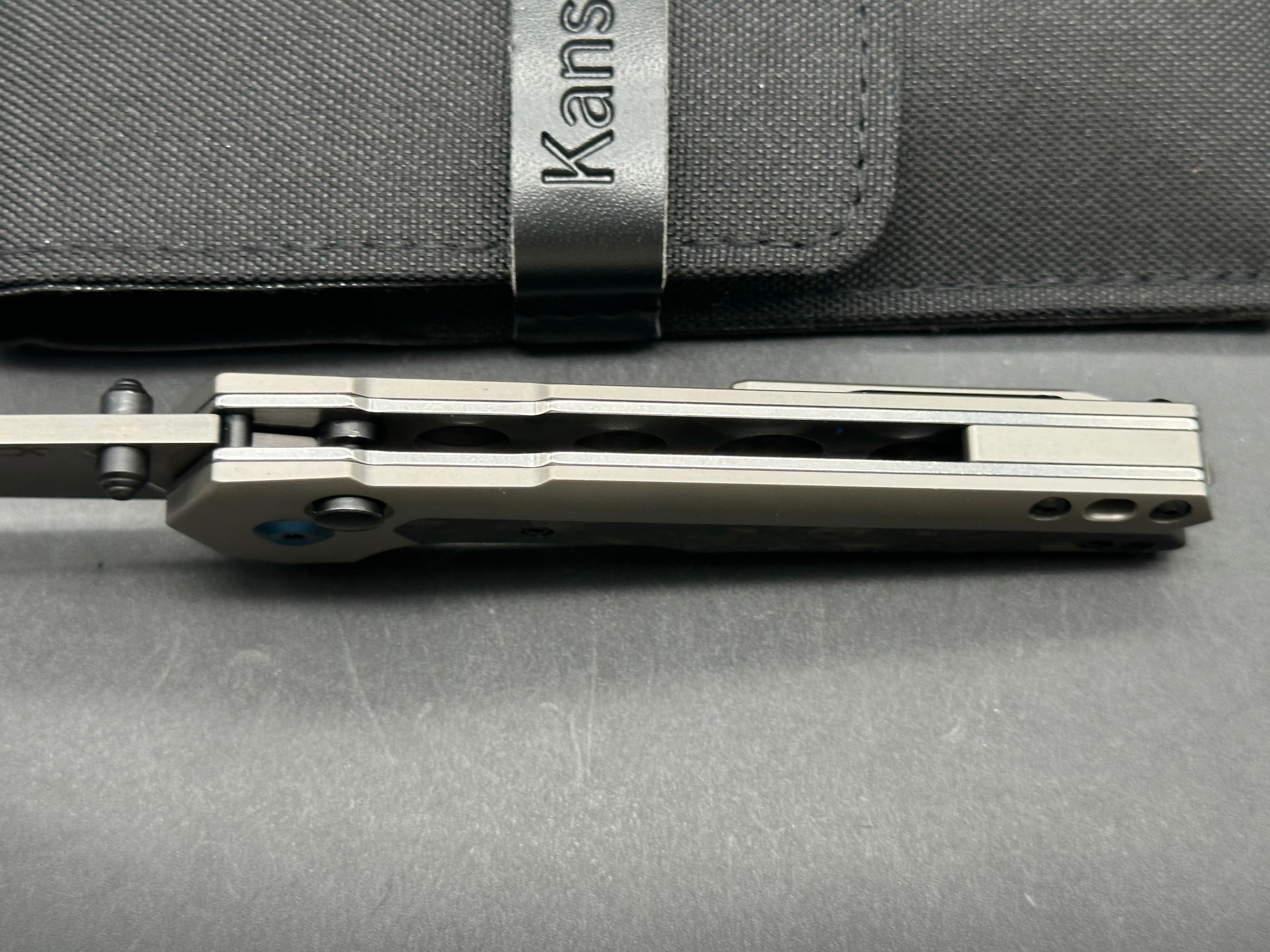 Kansept EDC Tac: Mikkel Willumsen design. 3.1 inch flat grind Damascus blade. Carbon fiber and titanium front and back scales