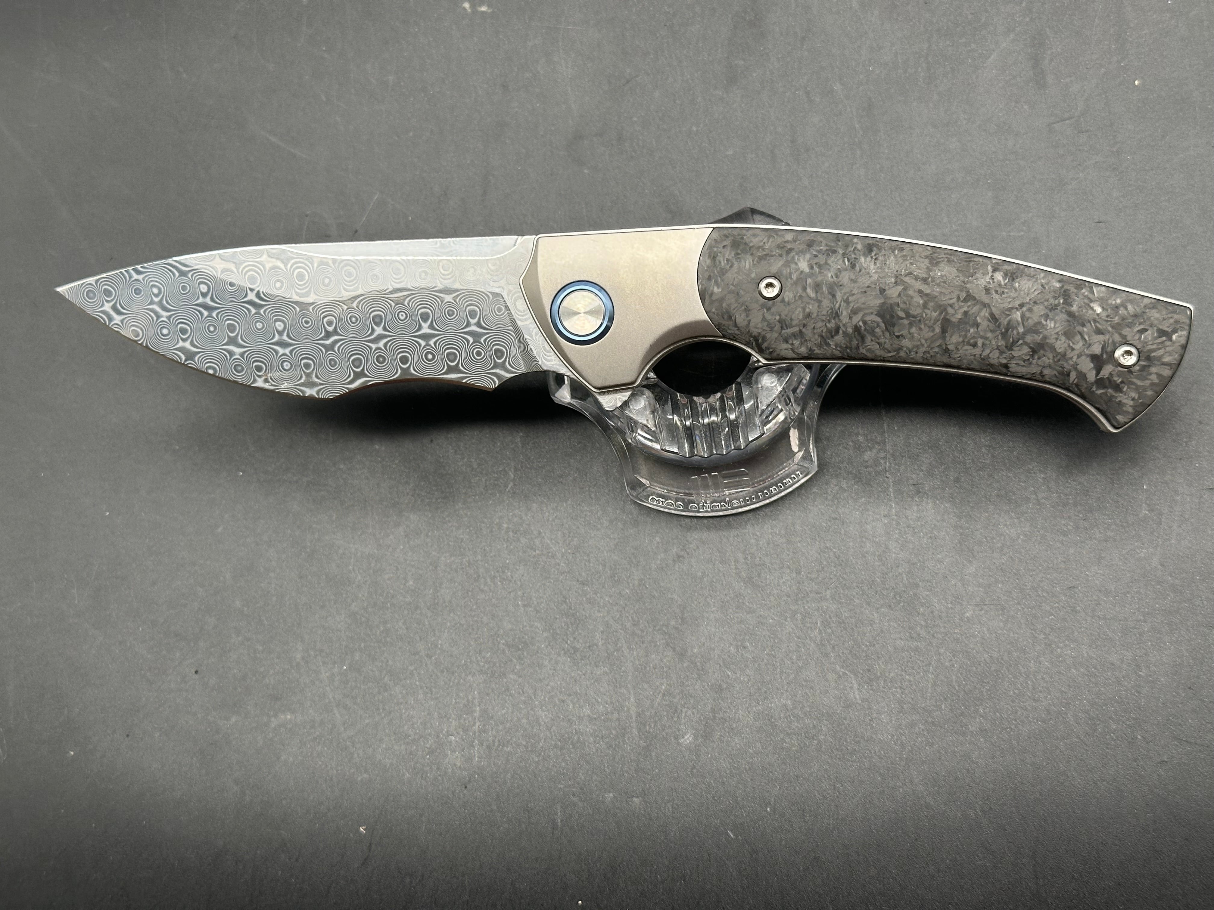 Sitivian ST255 / 3.5 inch polished Damascus blade. Titanium handle with carbon fiber inlays