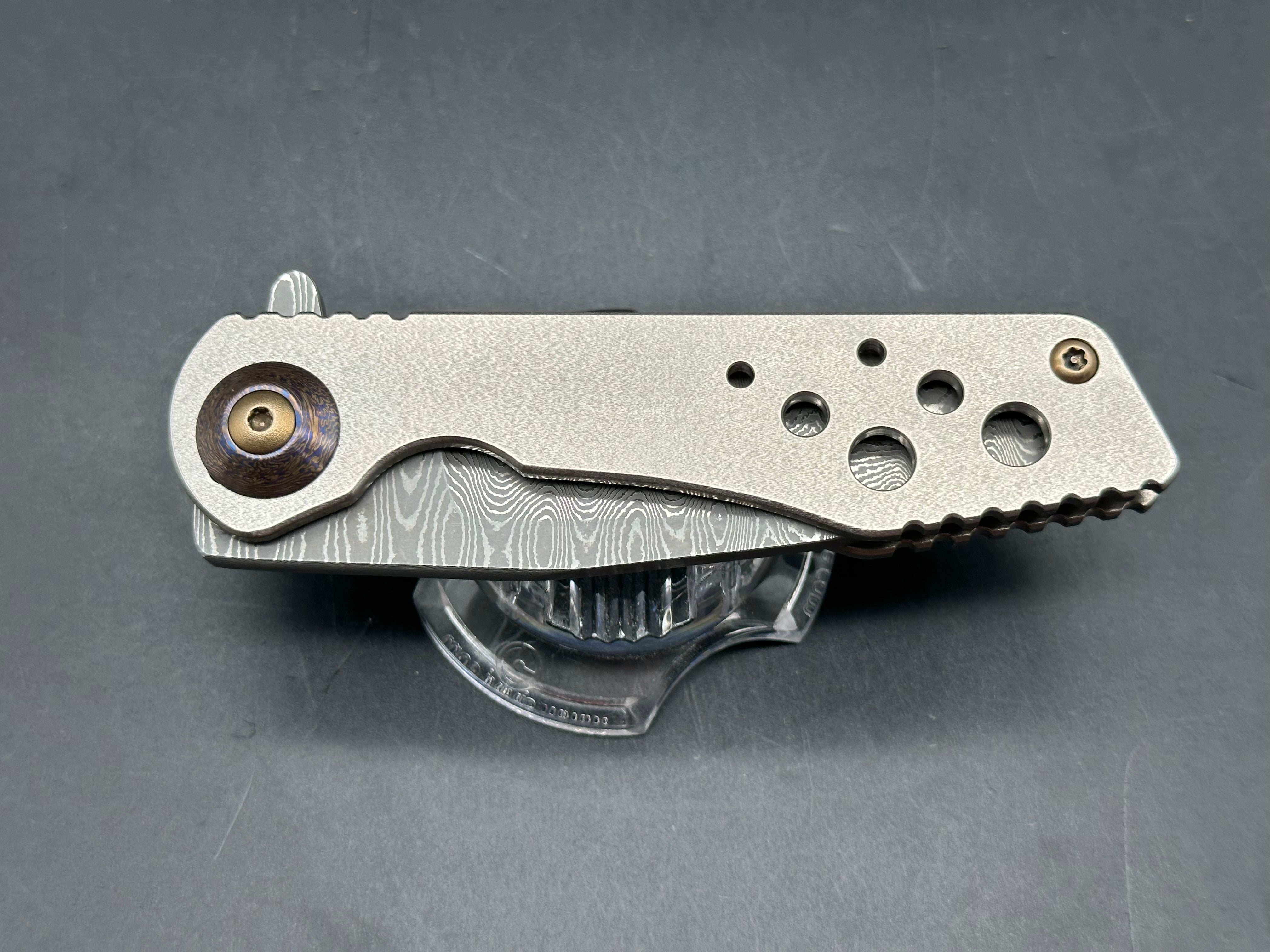 Jurgen Schanz Dress Flipper One-Off: 3.625 inch Damscus blade. Orange peel titanium frame. Mokuti pivot collars