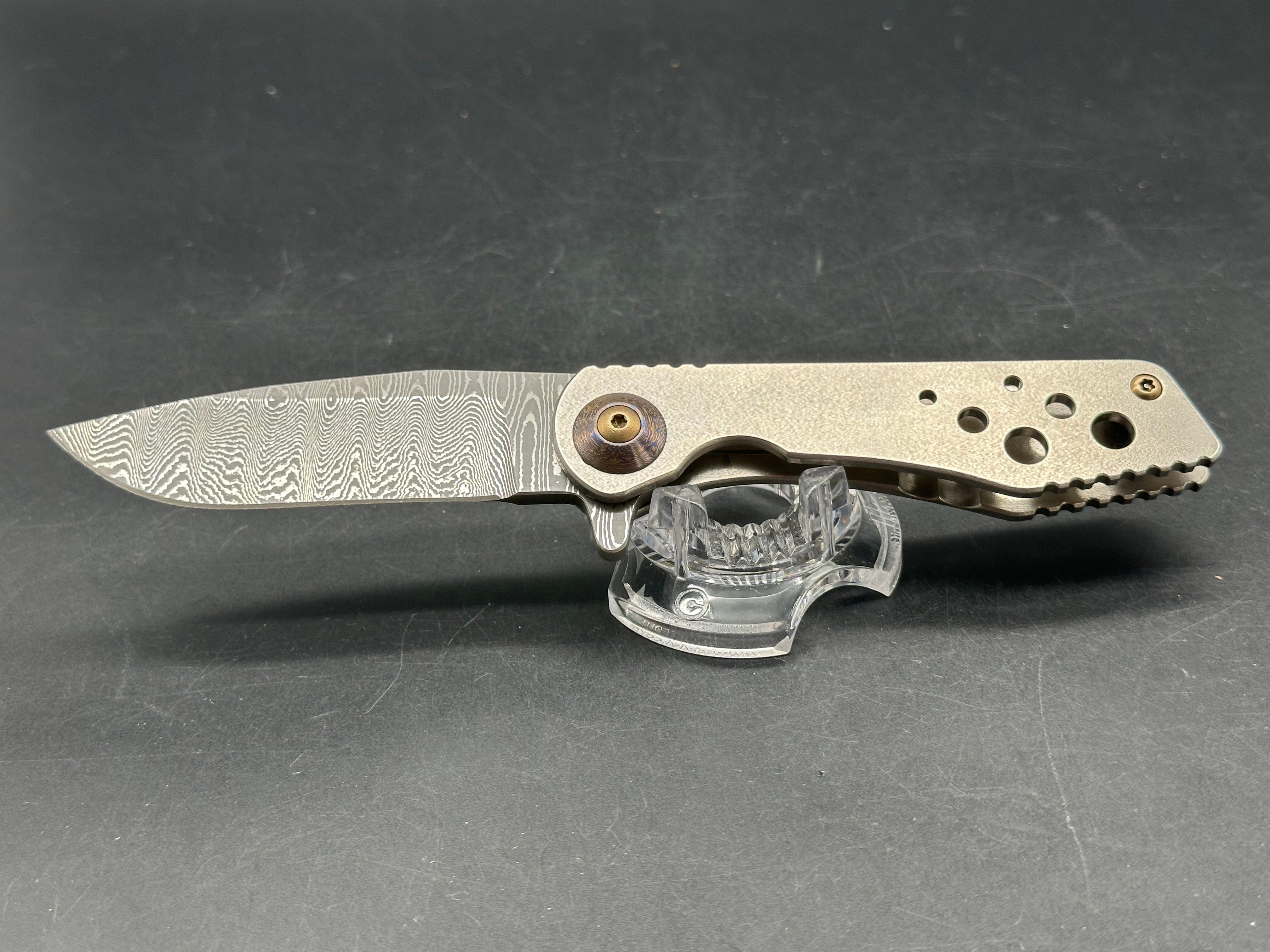 Jurgen Schanz Dress Flipper One-Off: 3.625 inch Damscus blade. Orange peel titanium frame. Mokuti pivot collars