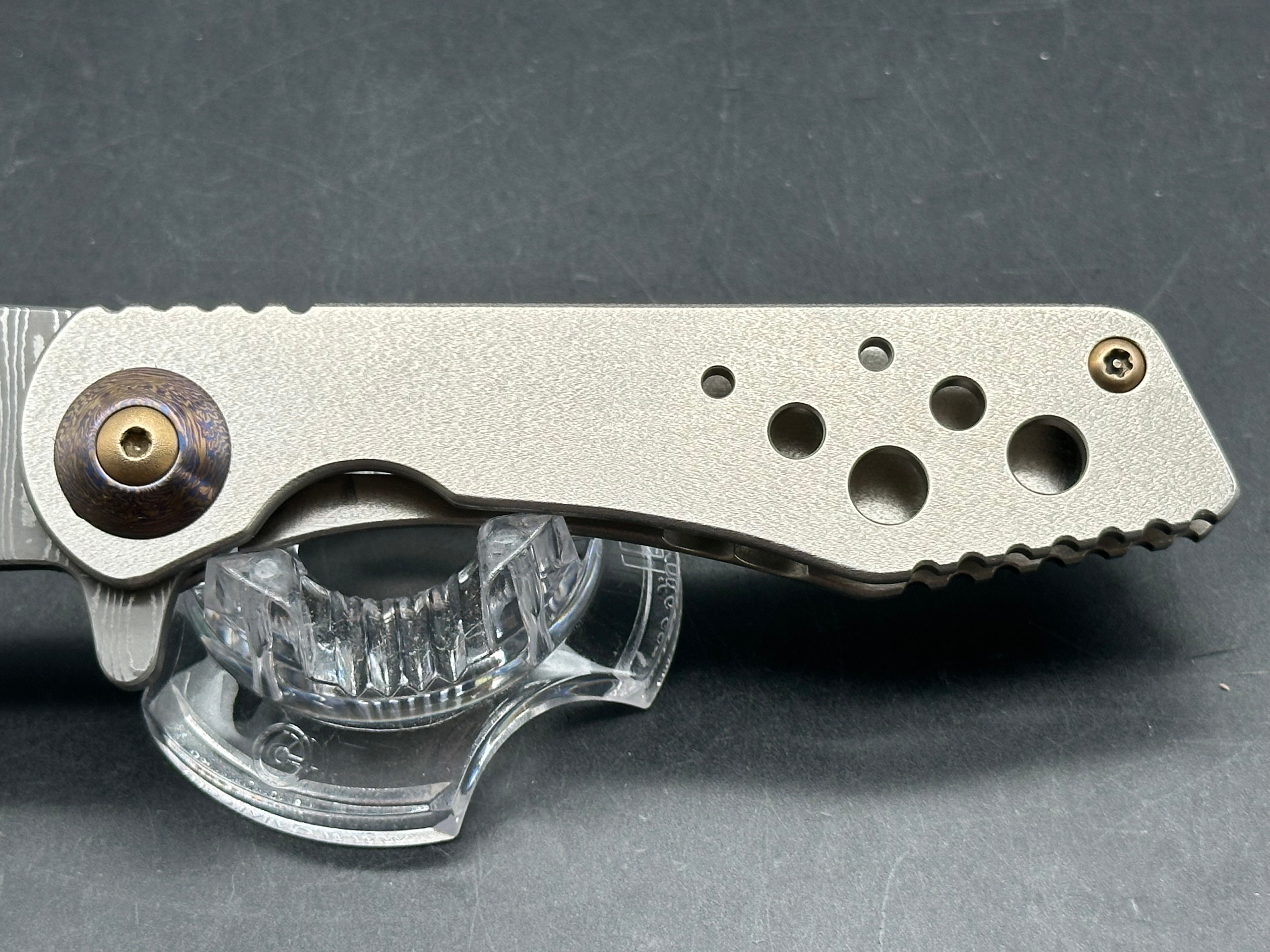 Jurgen Schanz Dress Flipper One-Off: 3.625 inch Damscus blade. Orange peel titanium frame. Mokuti pivot collars