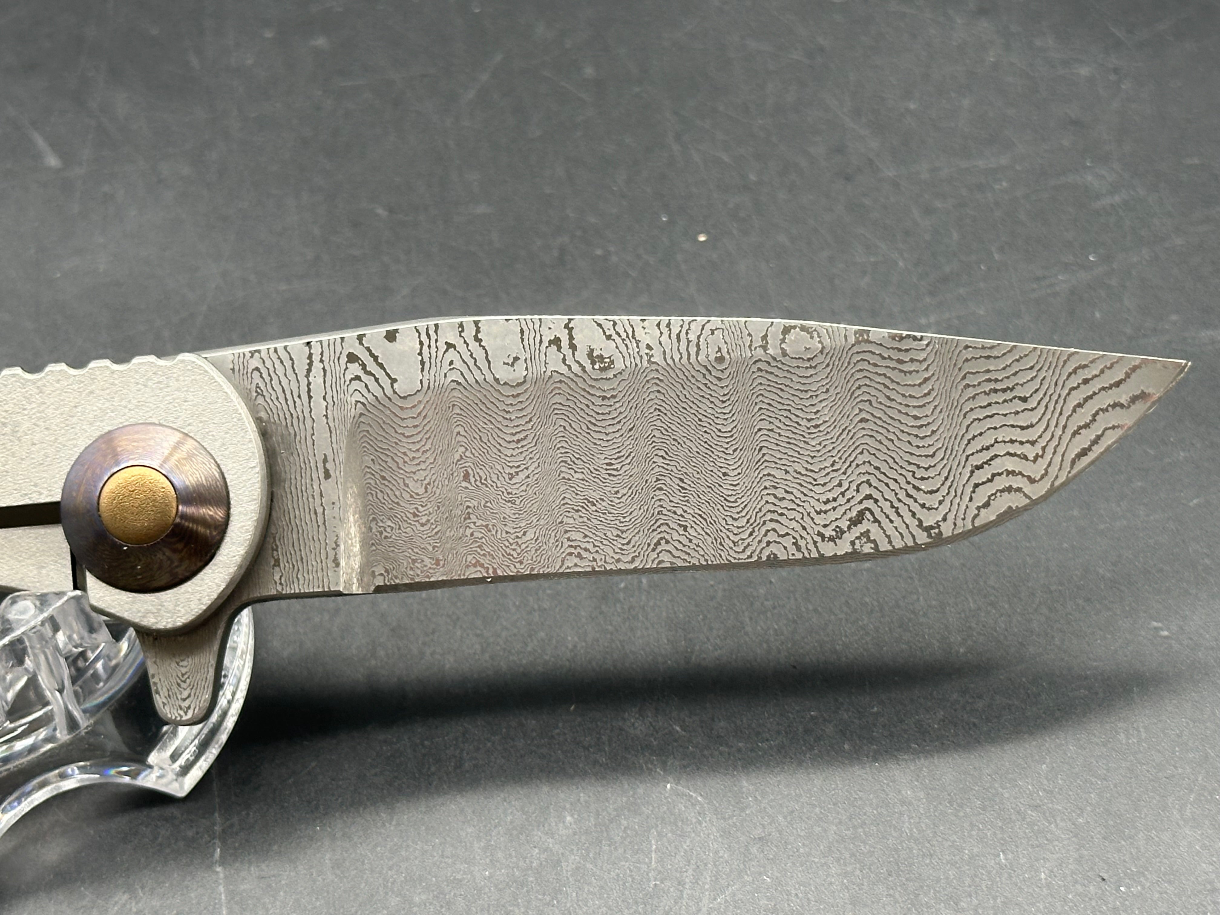 Jurgen Schanz Dress Flipper One-Off: 3.625 inch Damscus blade. Orange peel titanium frame. Mokuti pivot collars