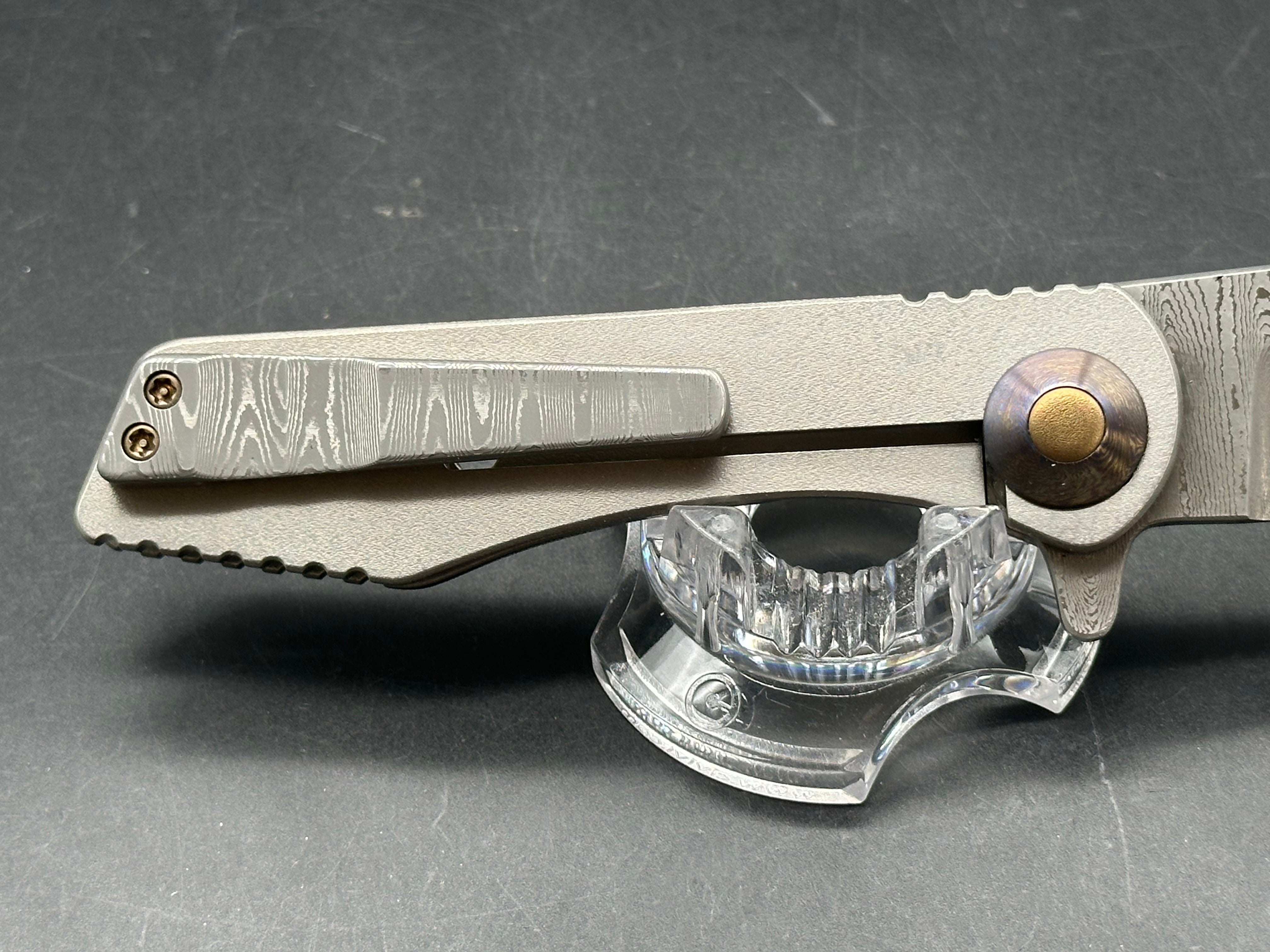 Jurgen Schanz Dress Flipper One-Off: 3.625 inch Damscus blade. Orange peel titanium frame. Mokuti pivot collars