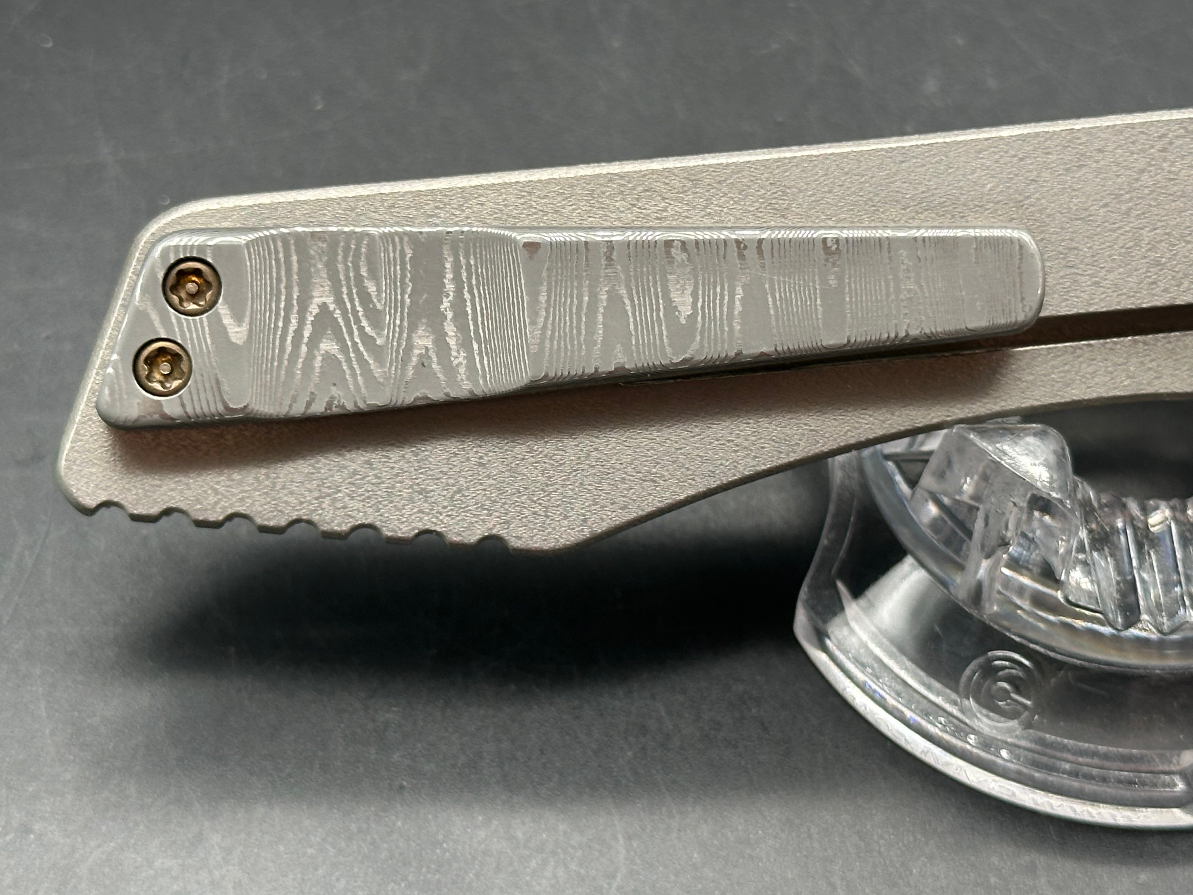 Jurgen Schanz Dress Flipper One-Off: 3.625 inch Damscus blade. Orange peel titanium frame. Mokuti pivot collars