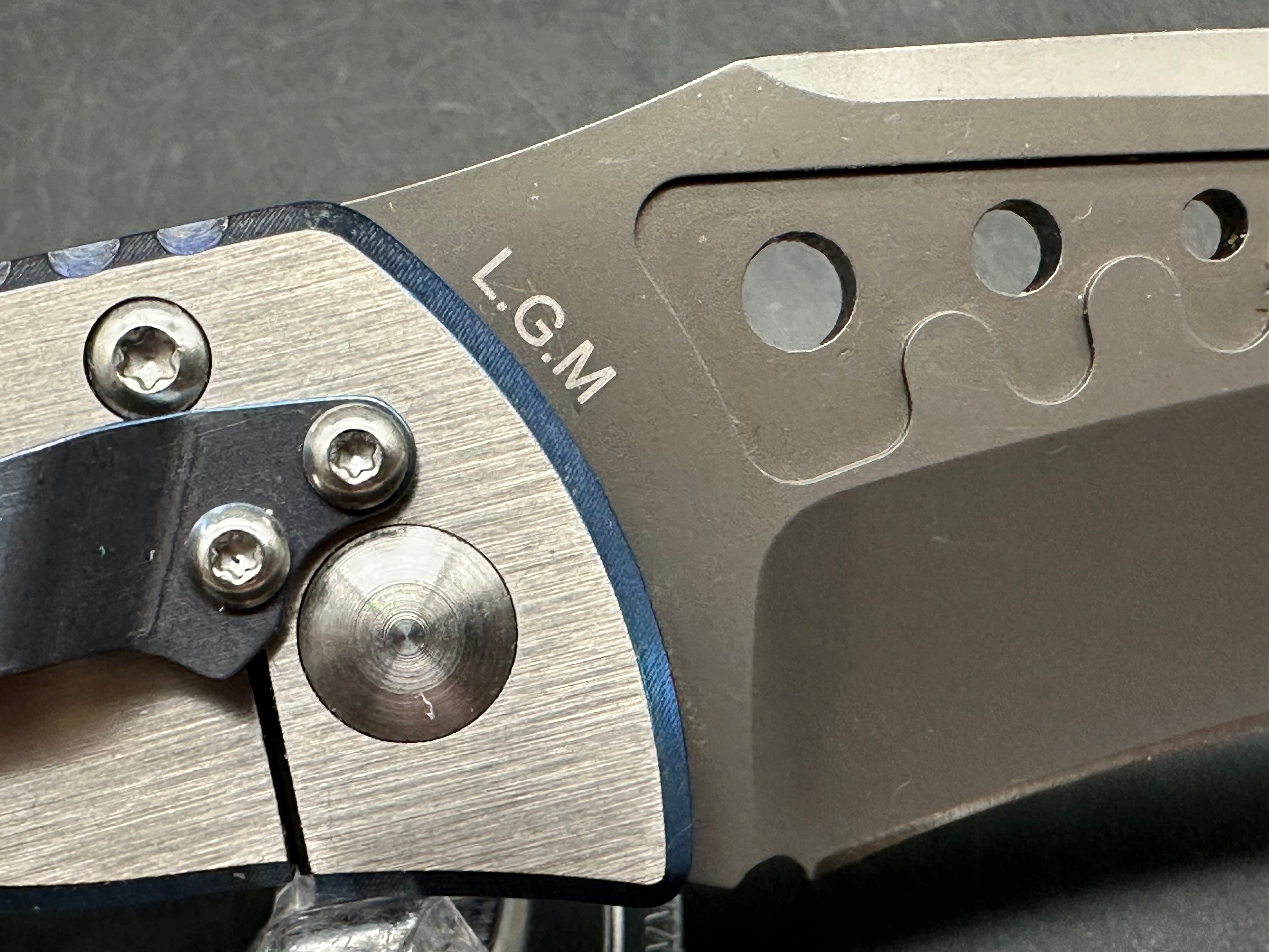 Kizer LGM: 4 inch titanium coated CPM-S35VN blade. Two tone anodized titanium frame