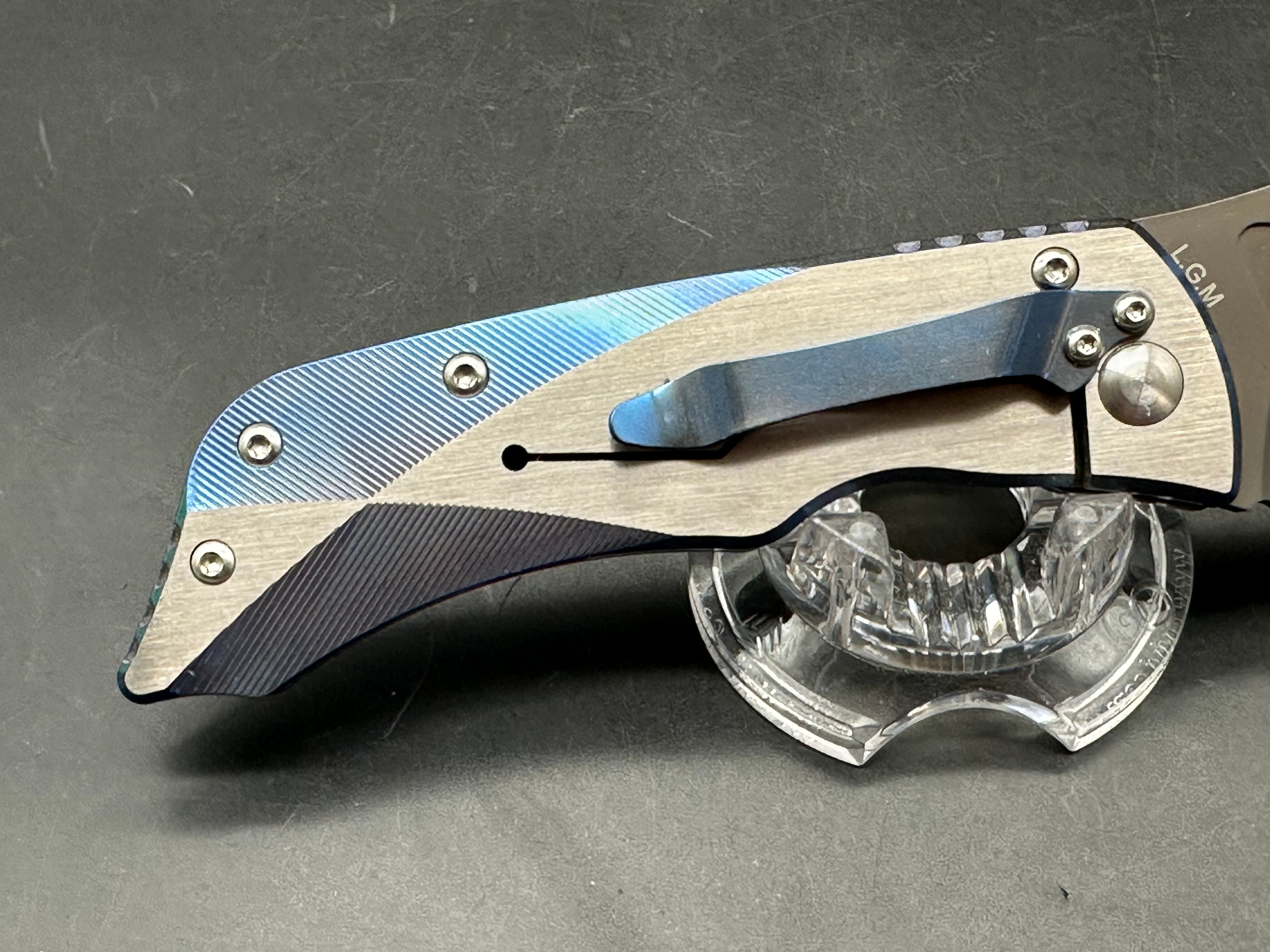 Kizer LGM: 4 inch titanium coated CPM-S35VN blade. Two tone anodized titanium frame