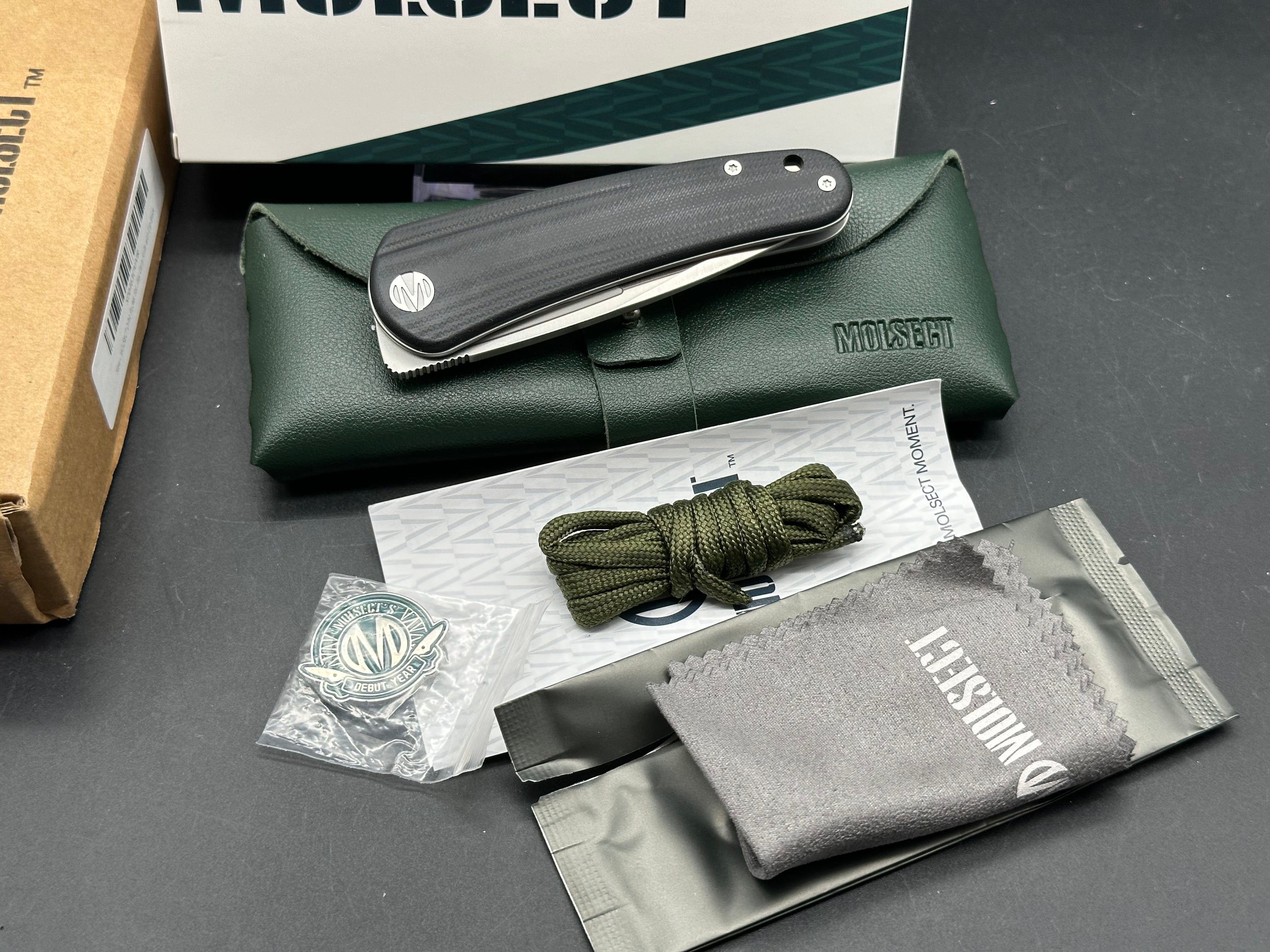 Molsect Orbit liner lock black G10 scales hollow grind 14C28N blade