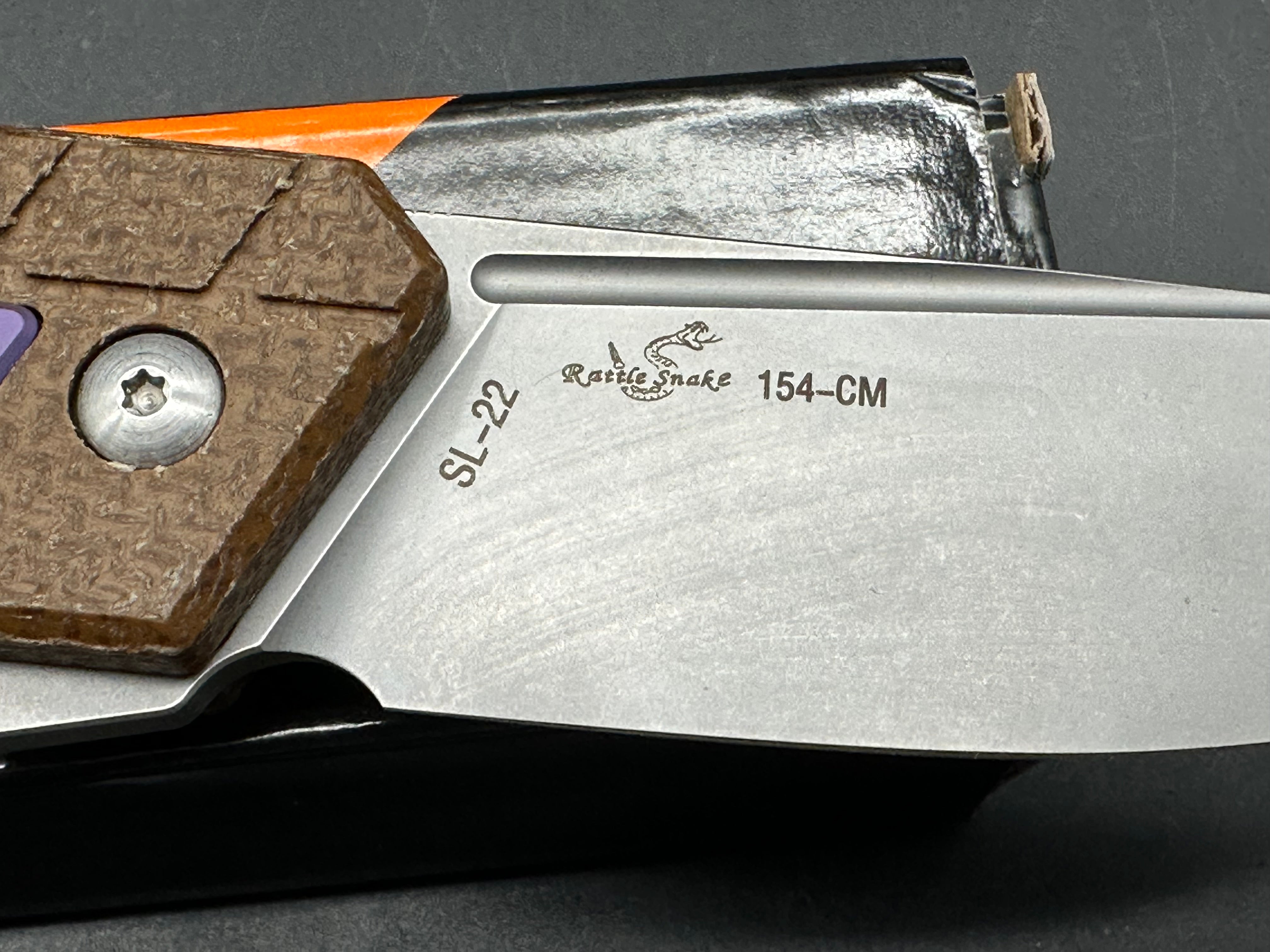 Sixleaf SL-22 PR  Rattlesnake design, button lock, micarta scales with purple titanium inserts and pocket clip, 154-CM blade