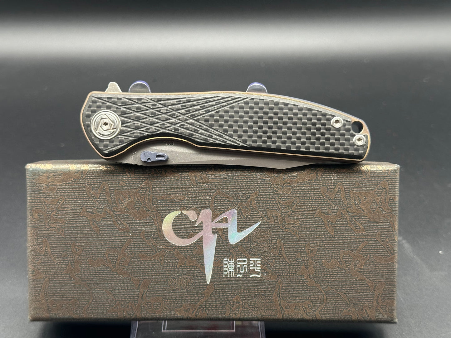 CH Knives CH3516 Bronze TI Frame, CF scales. Blue thumb studs, back spacer and clip