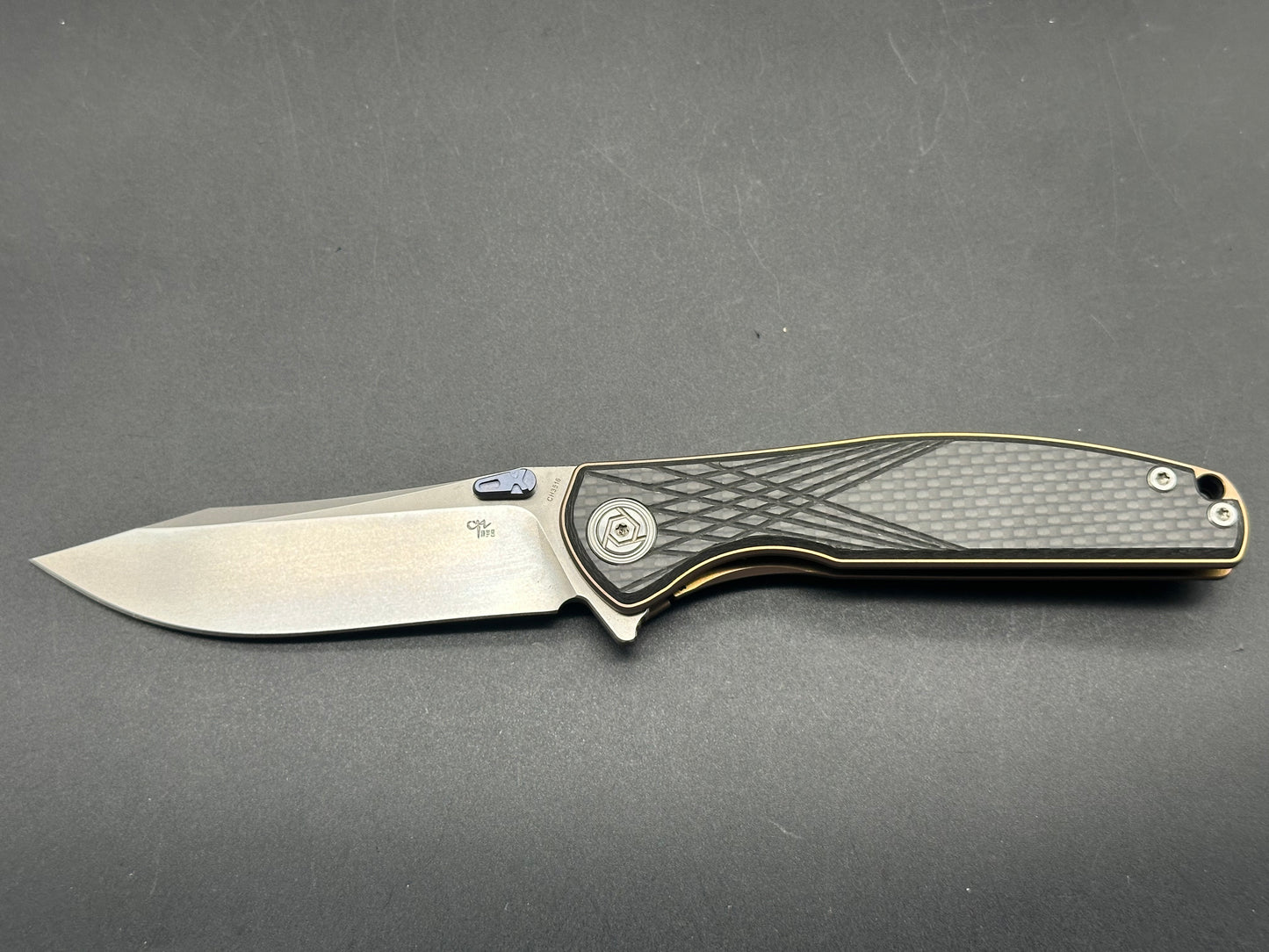 CH Knives CH3516 Bronze TI Frame, CF scales. Blue thumb studs, back spacer and clip