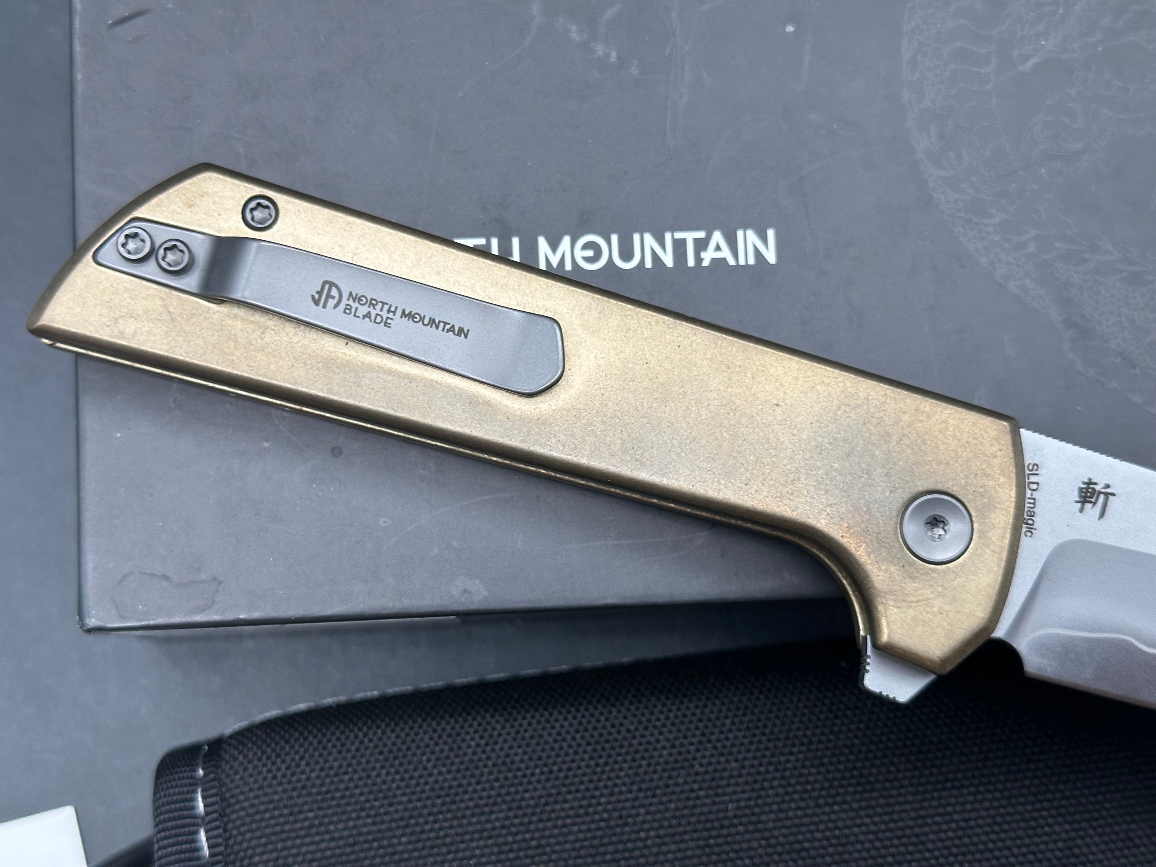 North Mountain Blade Chop 2 Button Lock Flipper Knife 3.5" SLD Hamon Drop Point Blade, Aluminum Bronze Handles with Speed Holes