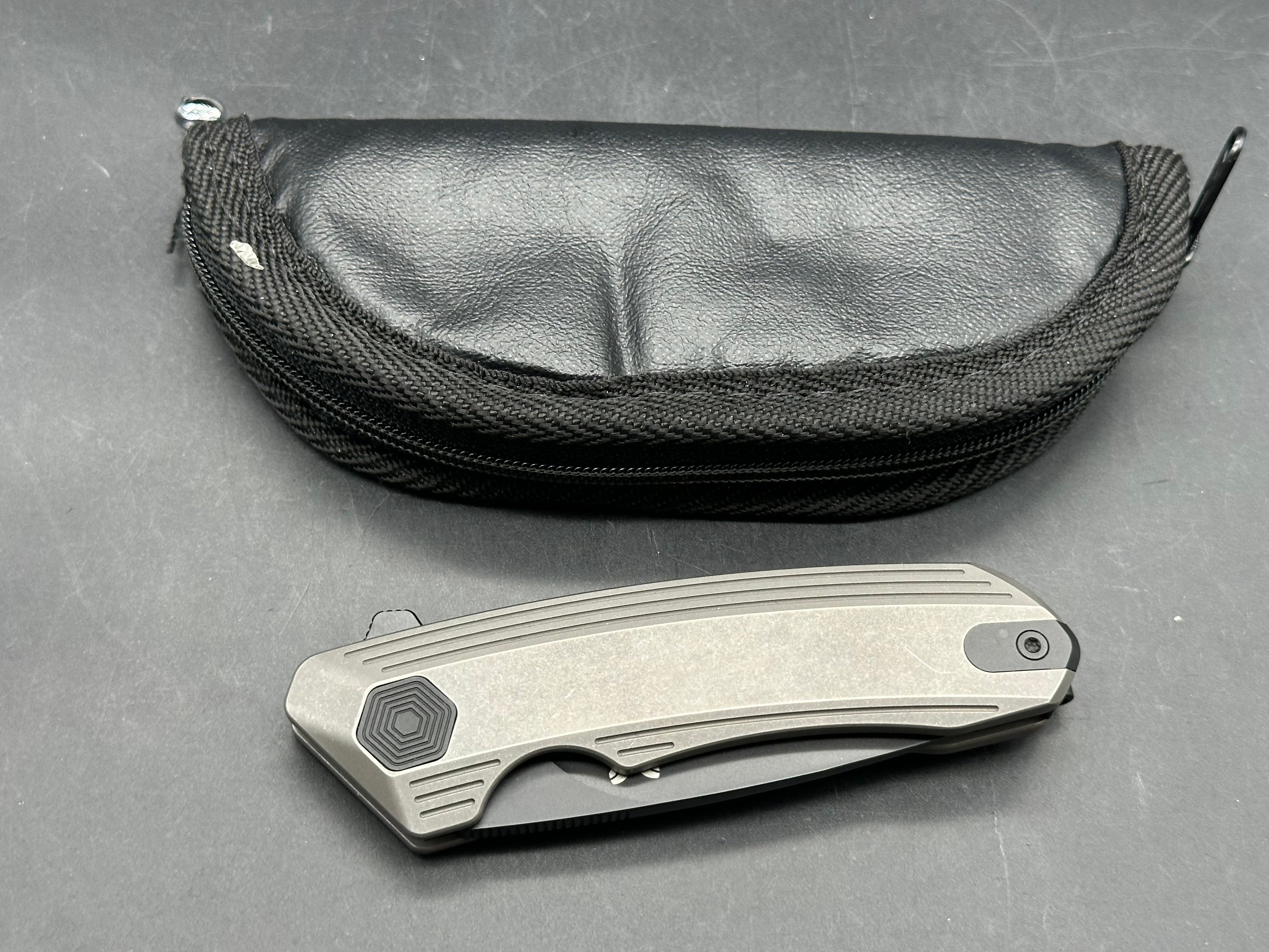 Damned Designs Invictus 3.5 inch 14C28N DLC coated blade. Titanium frame