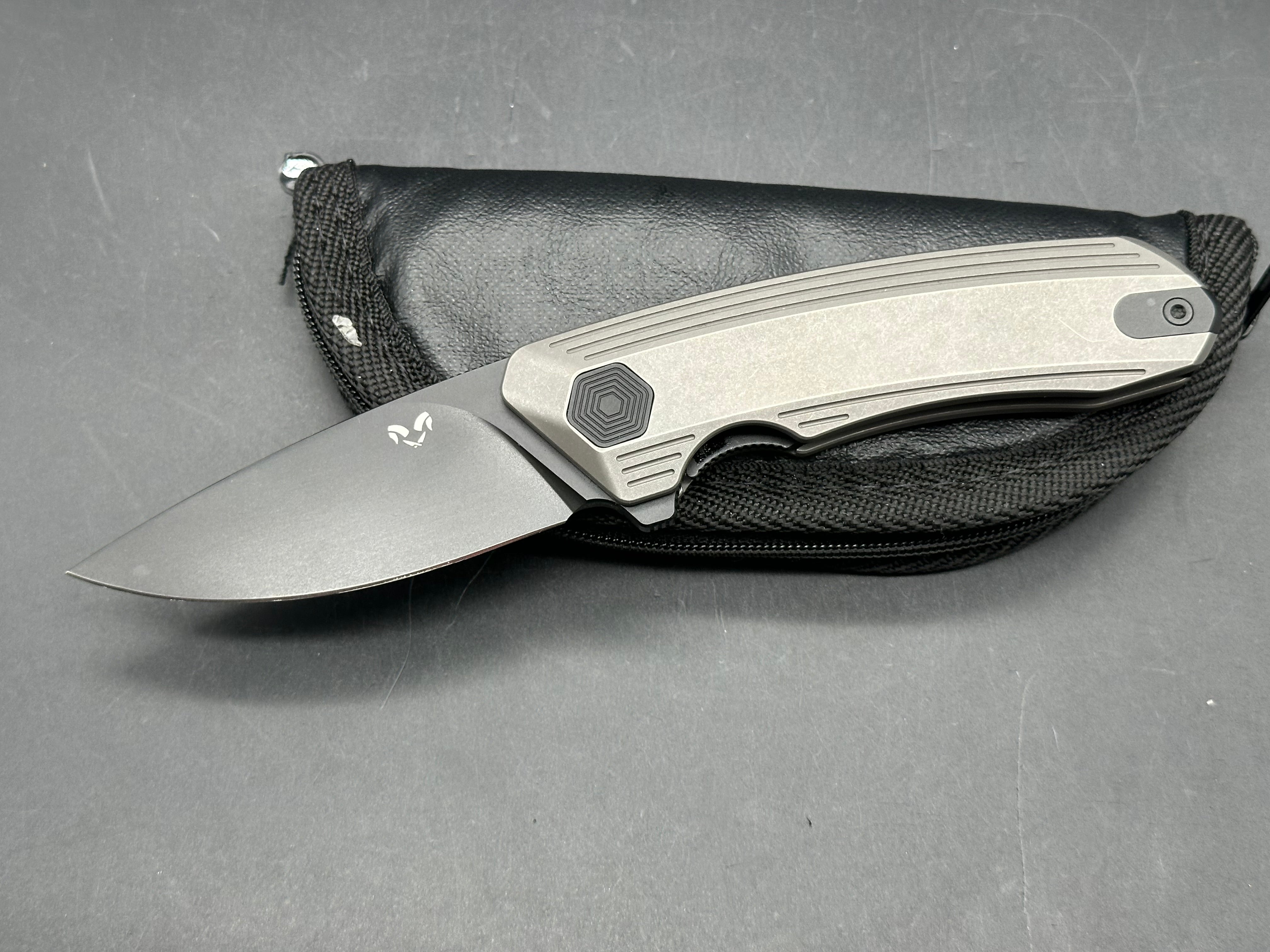 Damned Designs Invictus 3.5 inch 14C28N DLC coated blade. Titanium frame