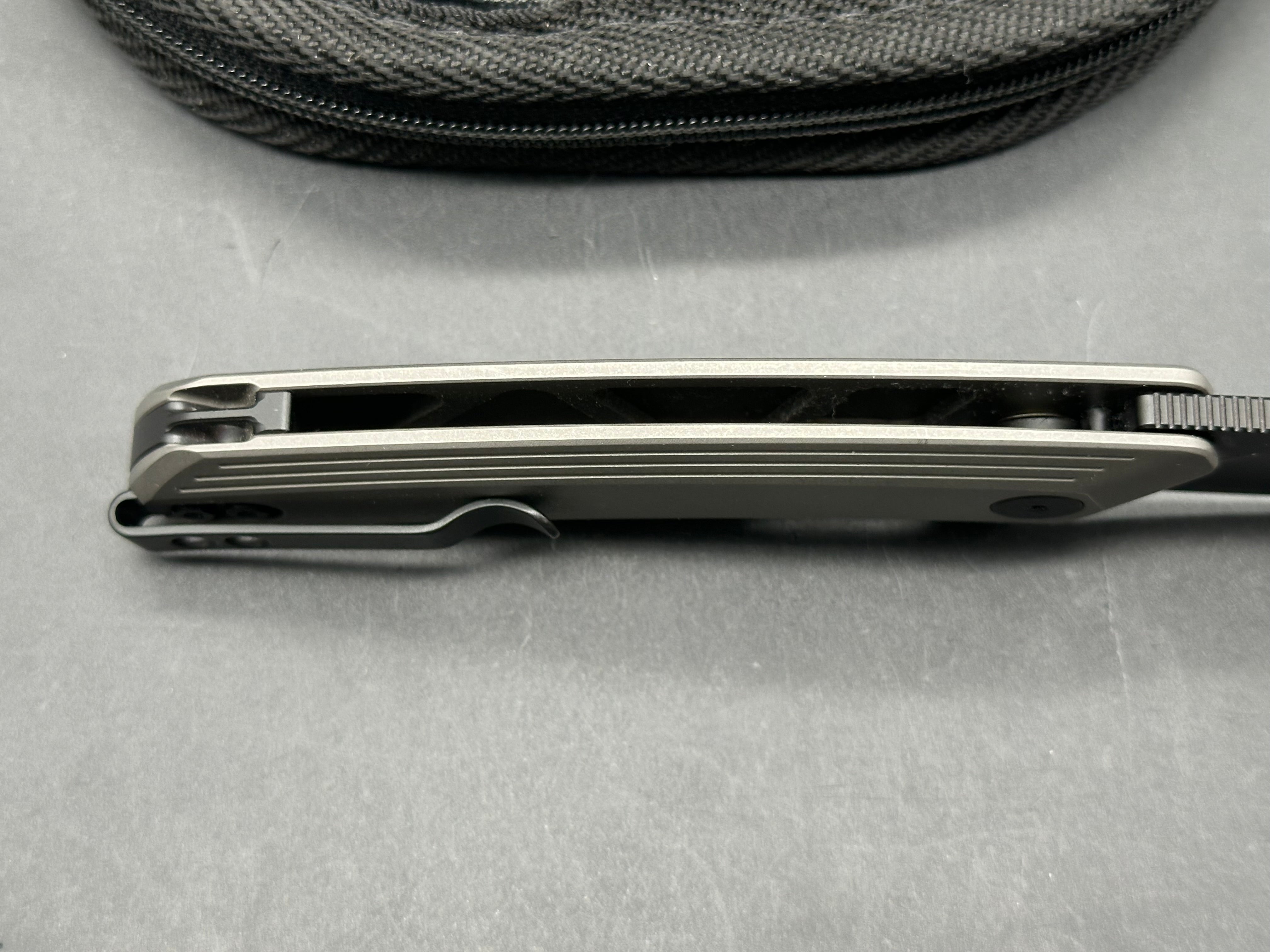 Damned Designs Invictus 3.5 inch 14C28N DLC coated blade. Titanium frame