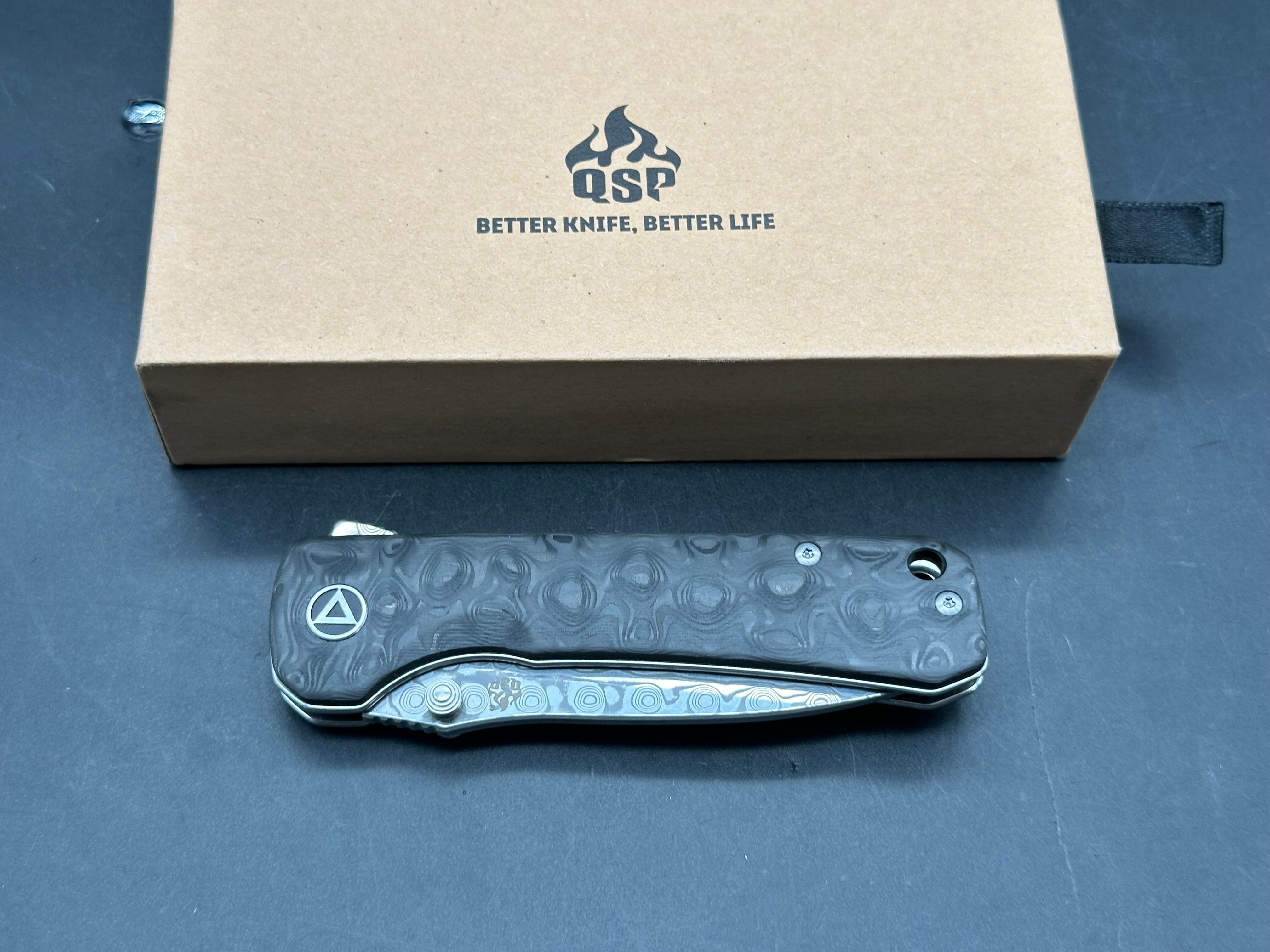 QSP Hawk 3.25 drop point, flat grind Damascus blade. Ceramic ball bearings. Marbled carbon fiber scales