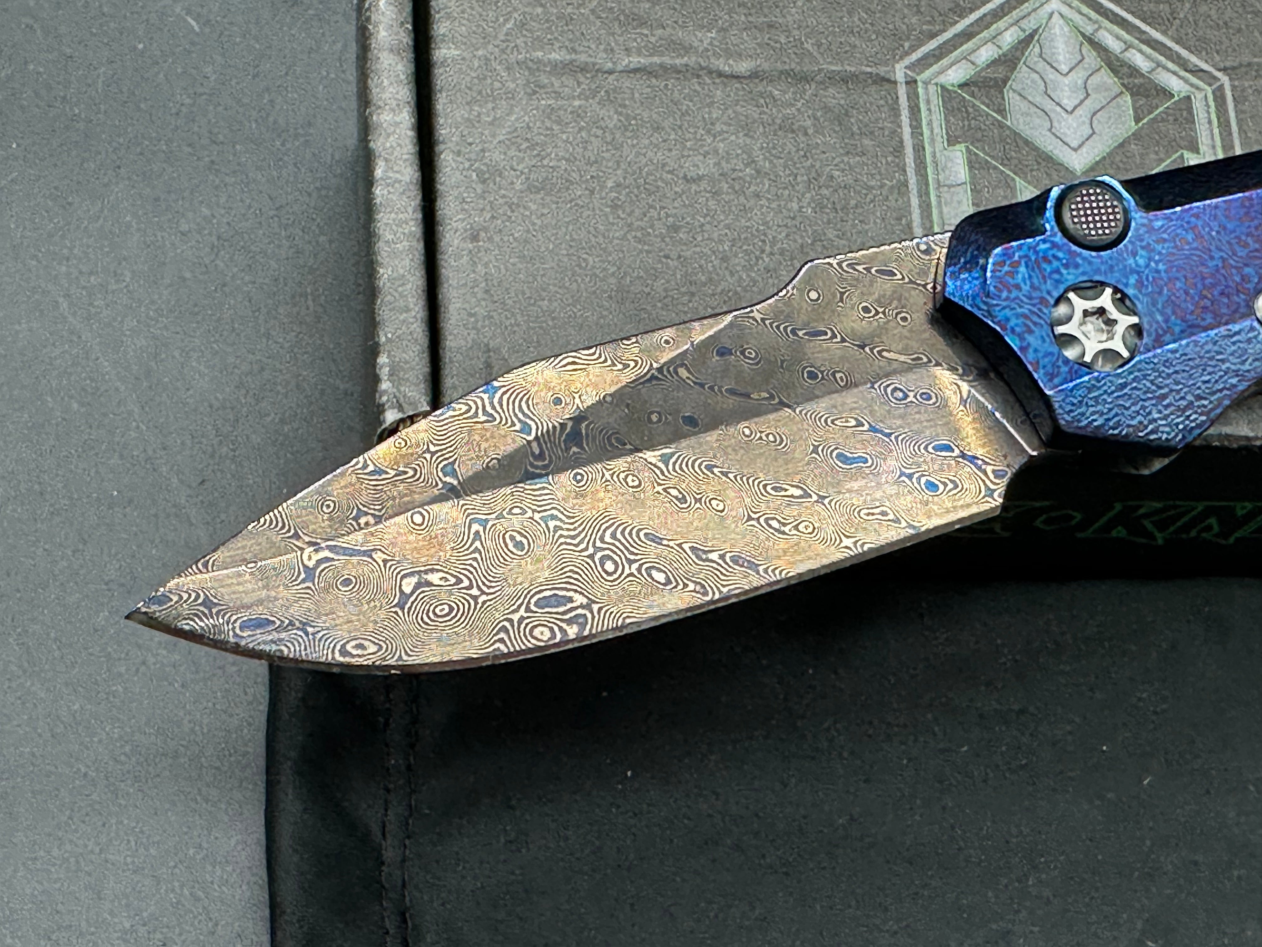 Heretic Wraith Integral Auto 3.75 inch clip point, polished and blued Vegas Forge Damascas blade
