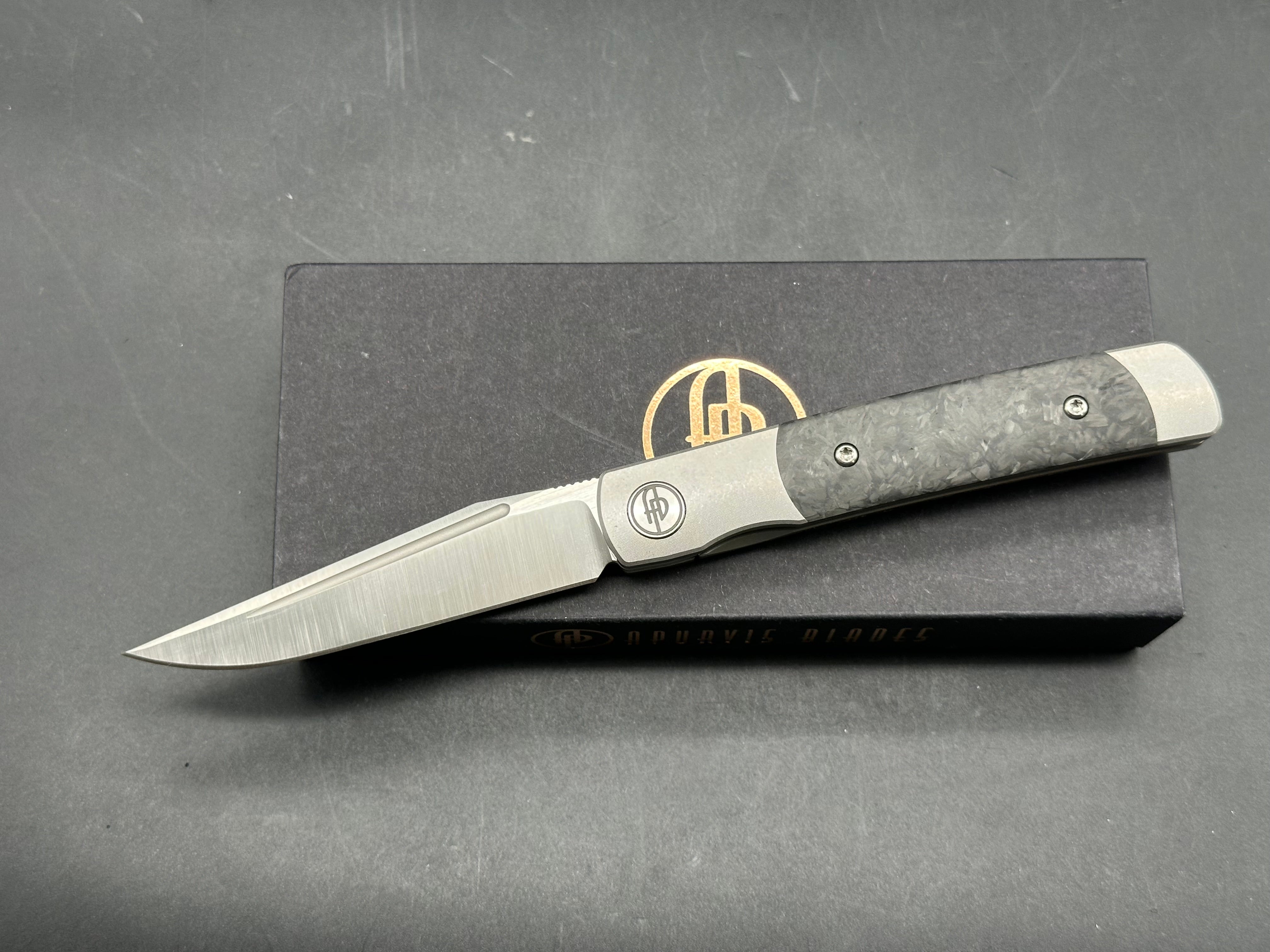 Adam Purvis Rook 3.3 inch vertical belt sanded CPM-20CV blade. Titaniu scales with marbled carbon fiber inlays. Satin hardware