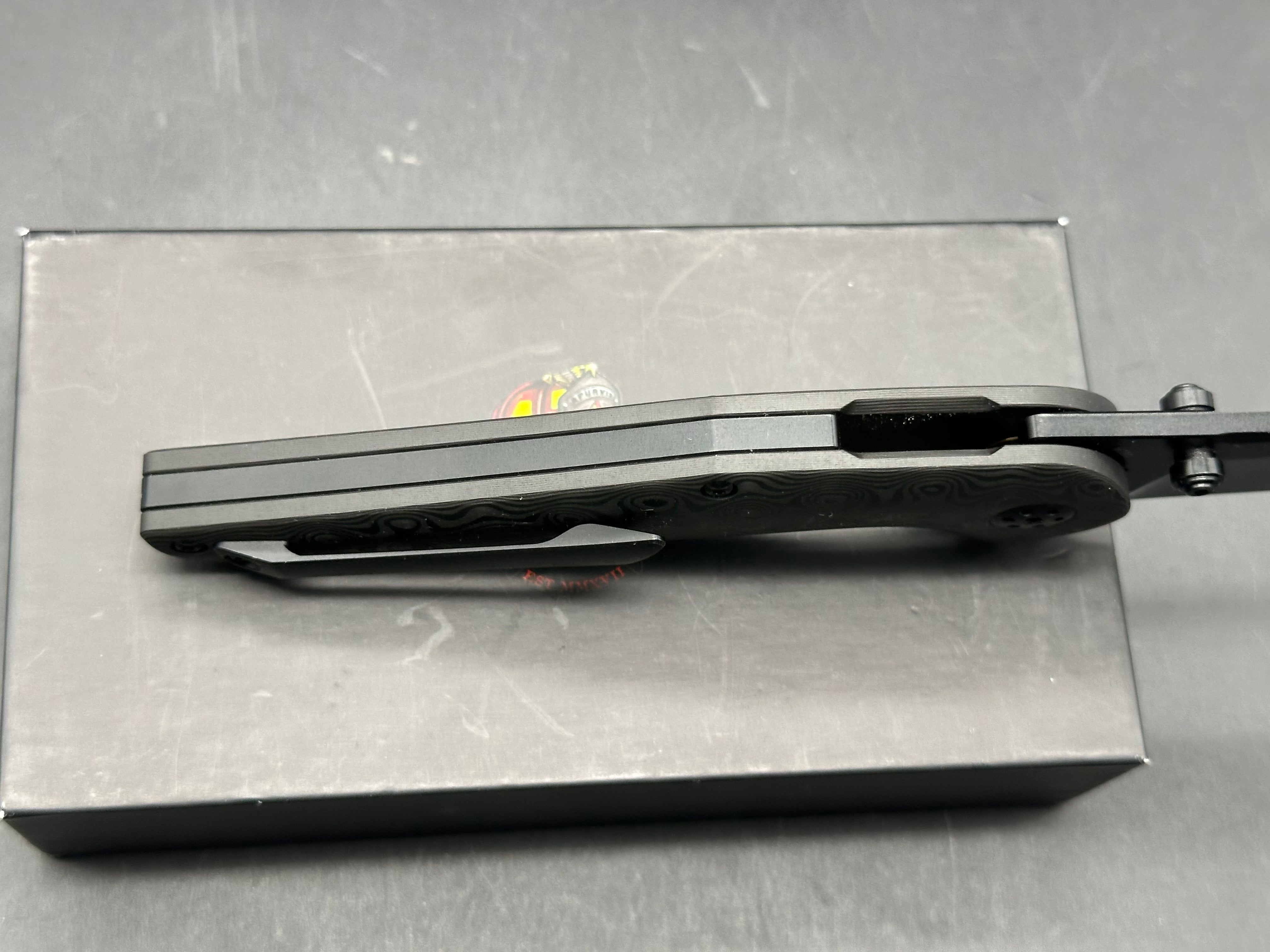 Adam Purvis Progeny 3.5 inch blackwashed, M390 blade. Raindrop carb fiber scales