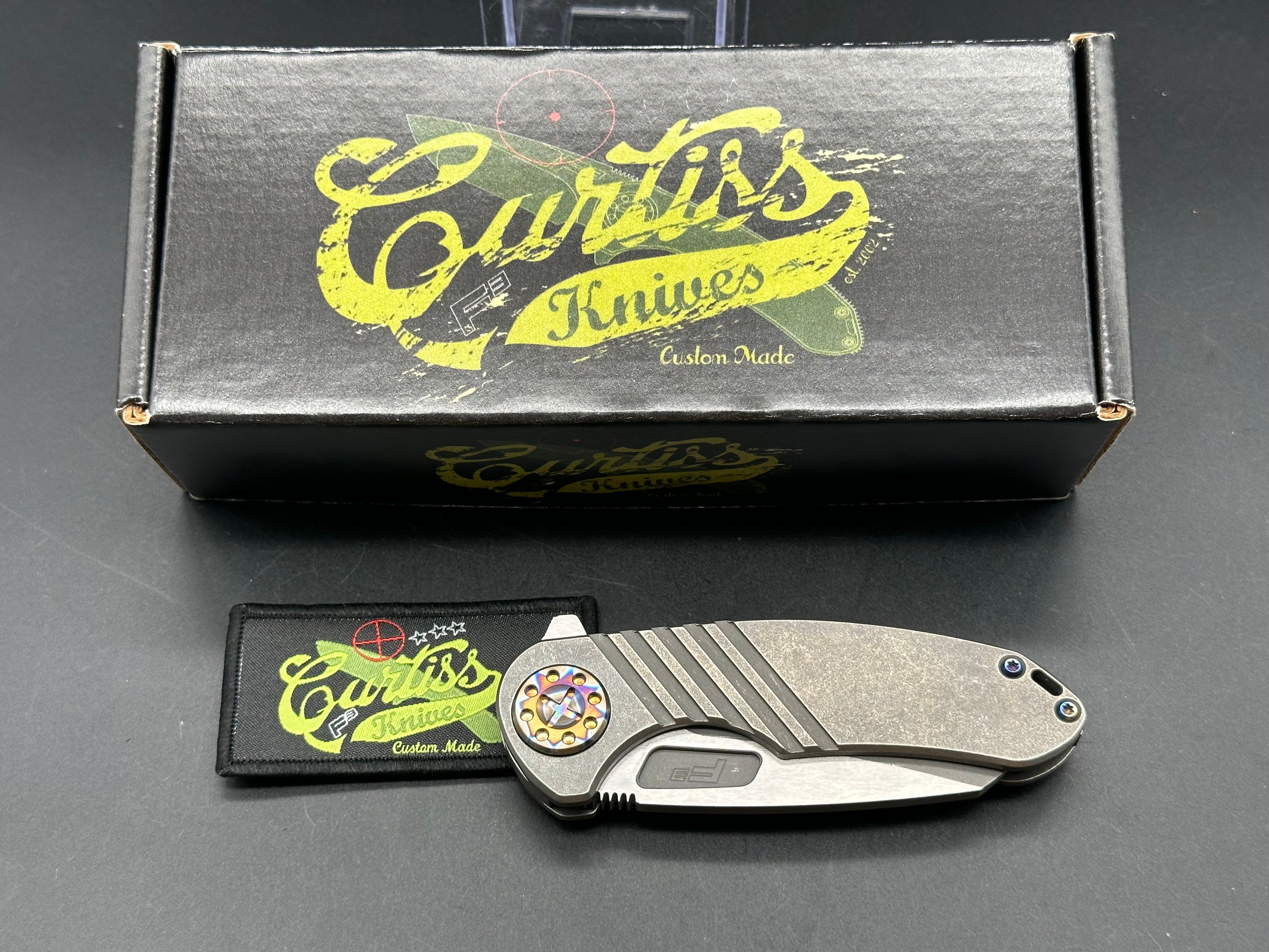 Curtiss F3 Medium Wharny flipper. Magnacut blade, titanium with polished bronzed hardware