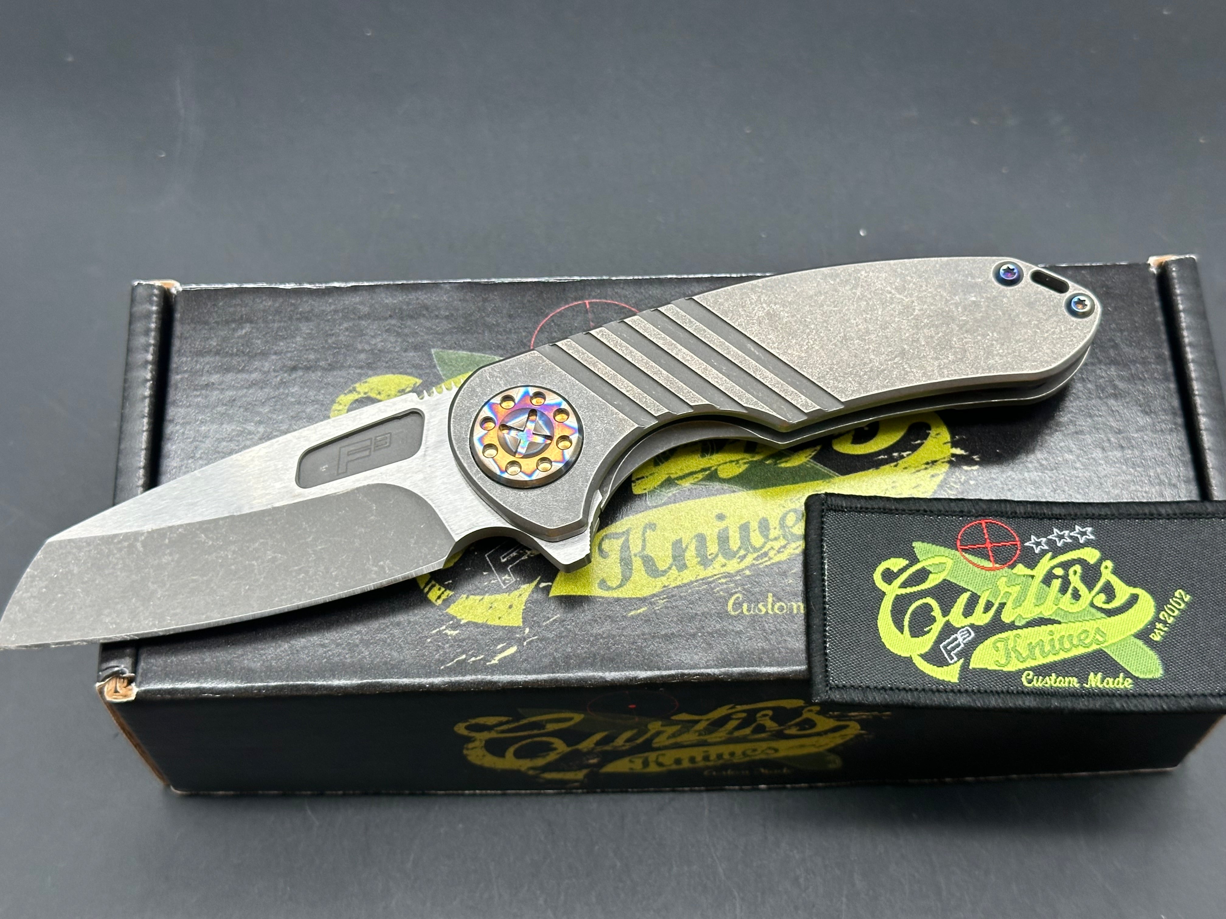 Curtiss F3 Medium Wharny flipper. Magnacut blade, titanium with polished bronzed hardware