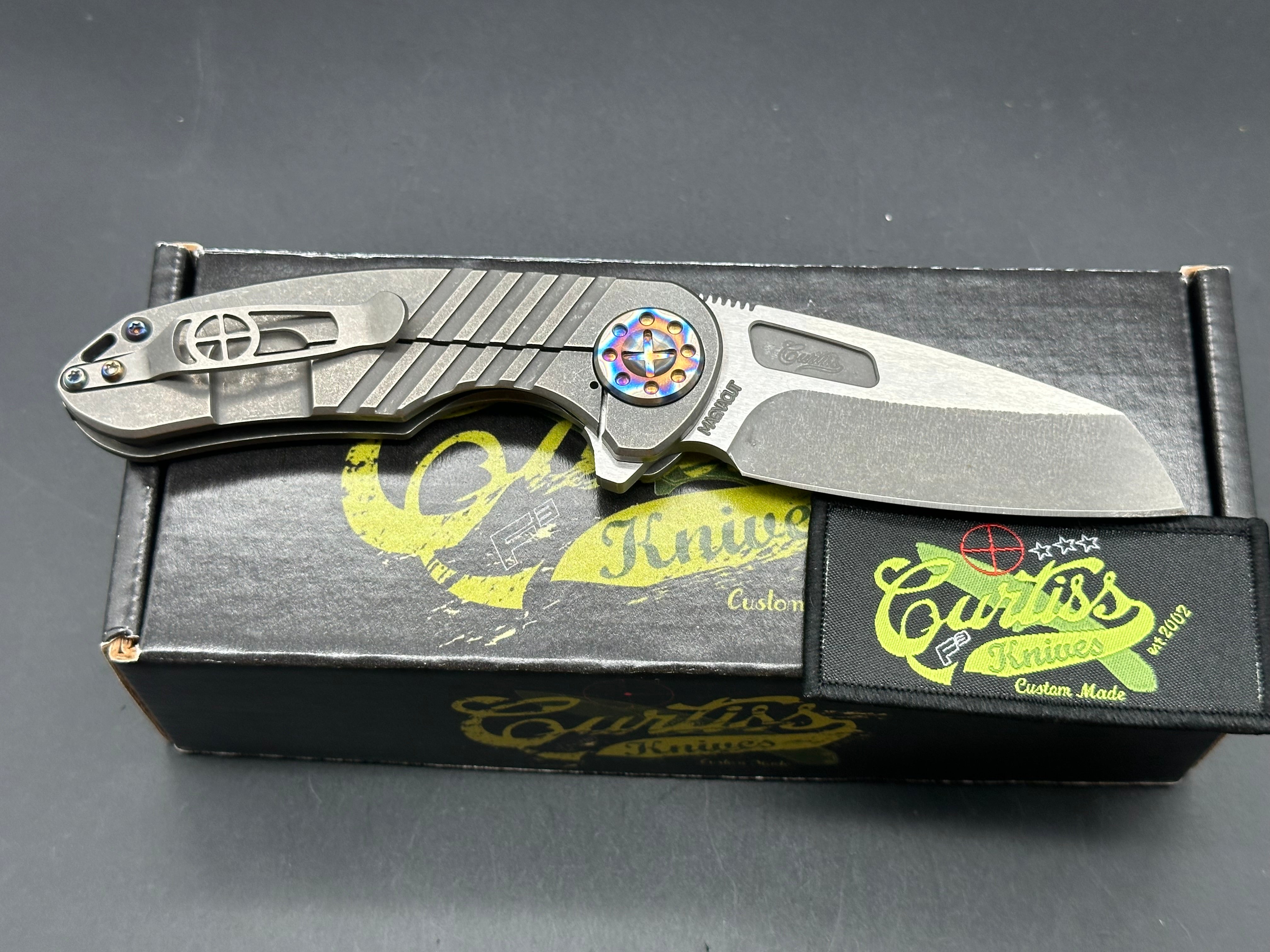 Curtiss F3 Medium Wharny flipper. Magnacut blade, titanium with polished bronzed hardware