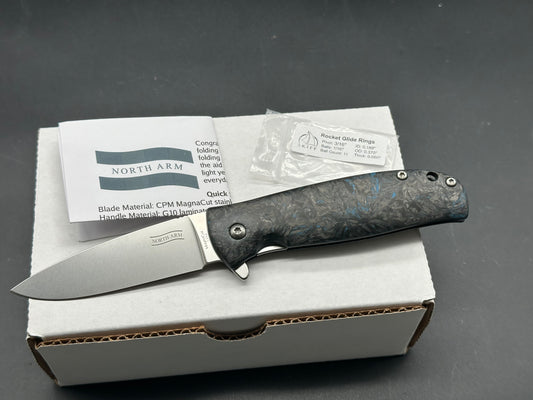 North Arm Skaha II, 3.34” Polished Stonewash MagnaCut Drop Point Blade with Blue Dark Matter Fat Carbon Handle (Serial #3154)