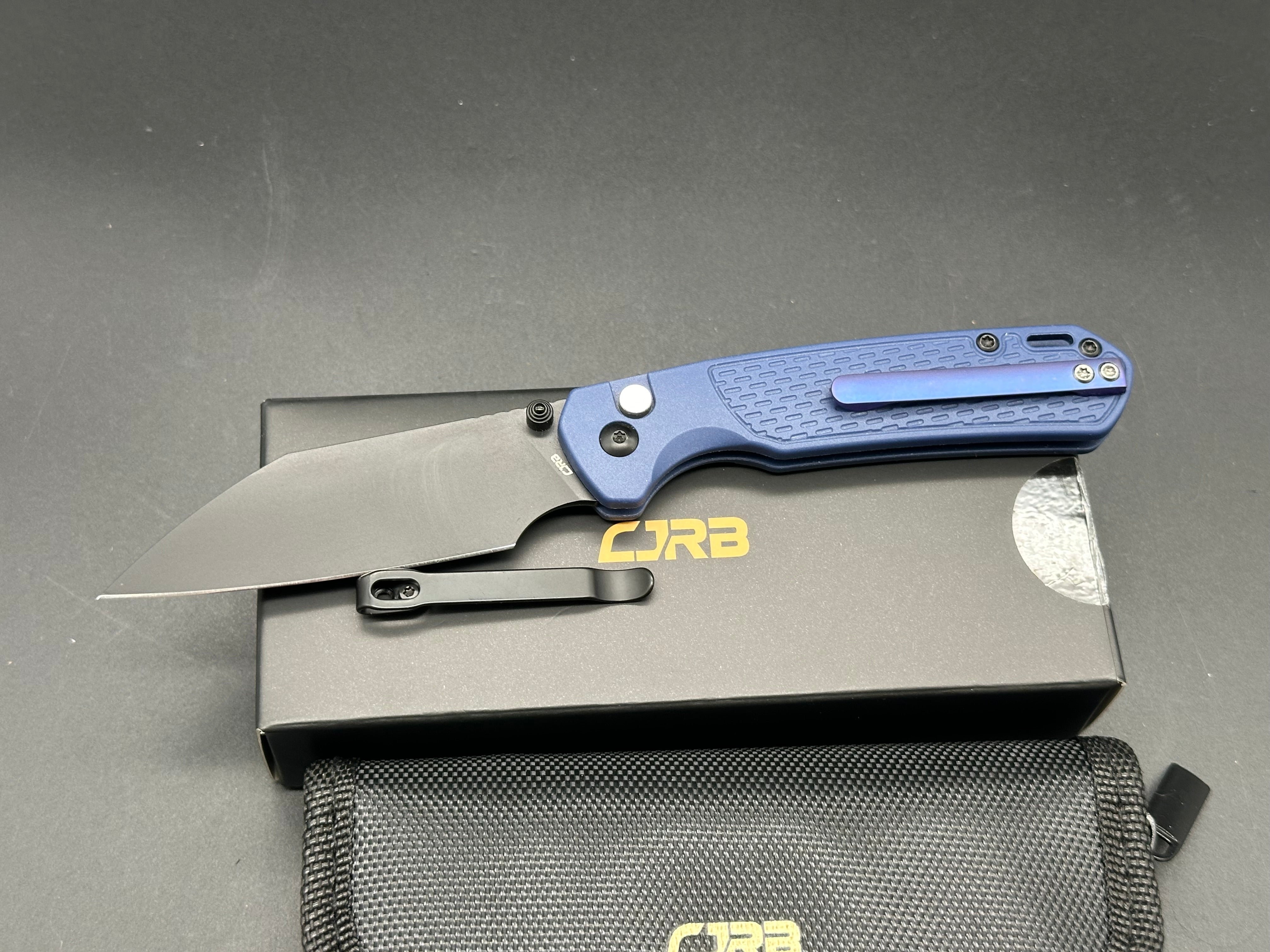 CJRB Pyrite-Light Button Lock/Thumb Stud Blue FRN scales with blue titanium pocket clip (3.34" AR-RPM9 Black PVD Wharncliffe)