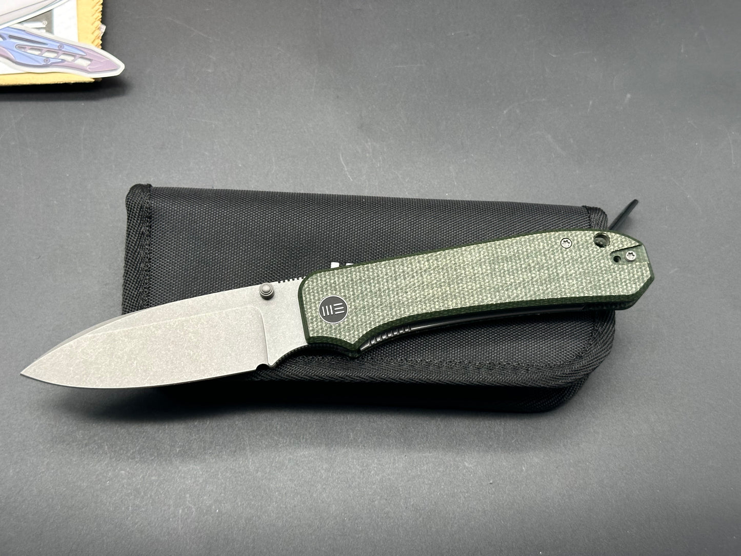 WE BIG BANTER FOLDING KNIFE GREEN CANVAS MICARTA HANDLE 20CV DROP POINT