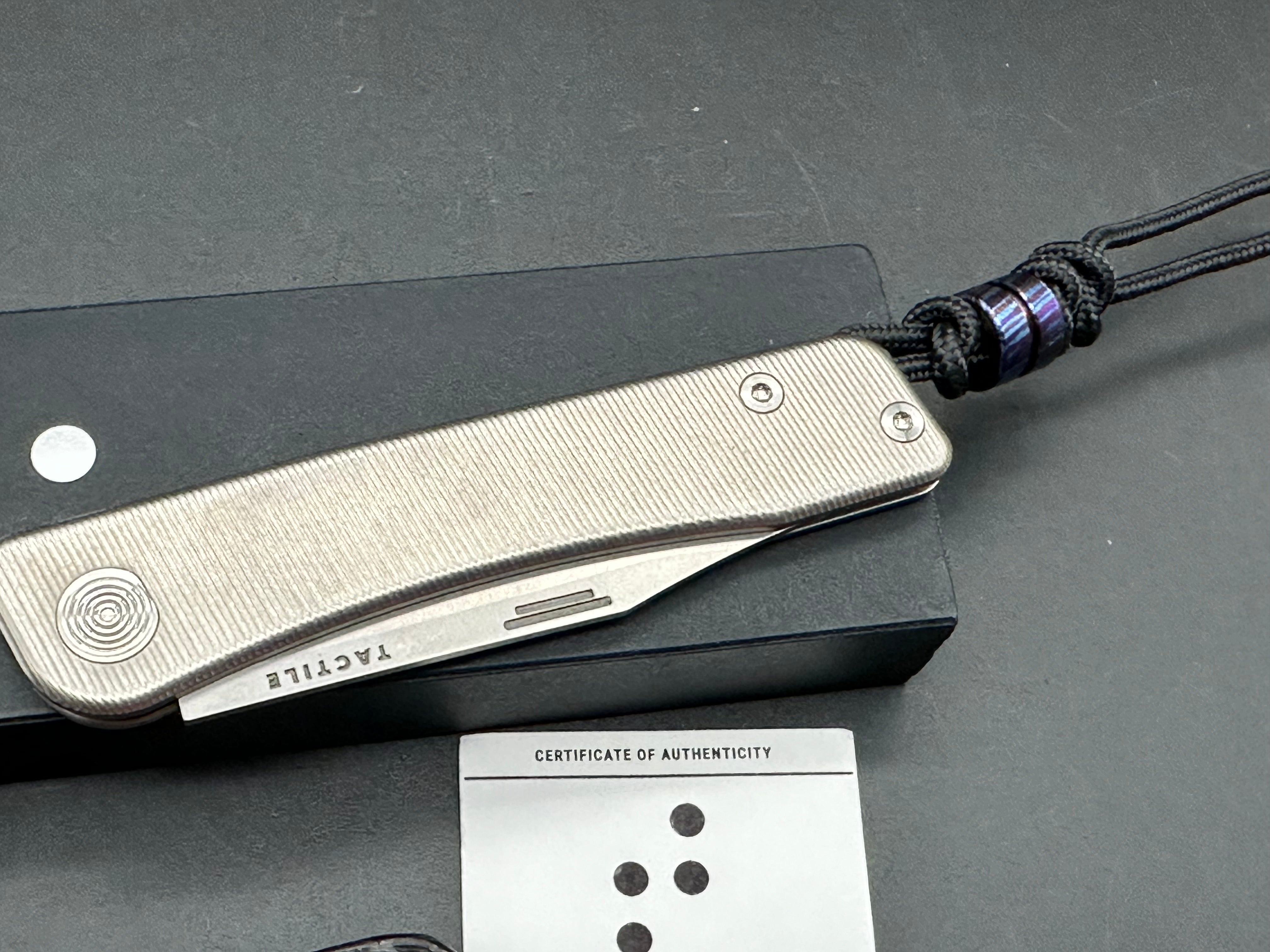 Tactile Bexar Titainum Magnacut has leather slip and timascus bead