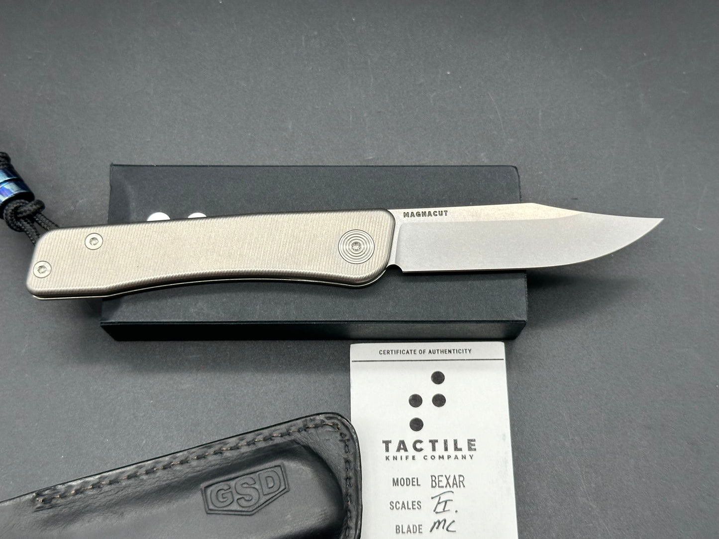 Tactile Bexar Titainum Magnacut has leather slip and timascus bead