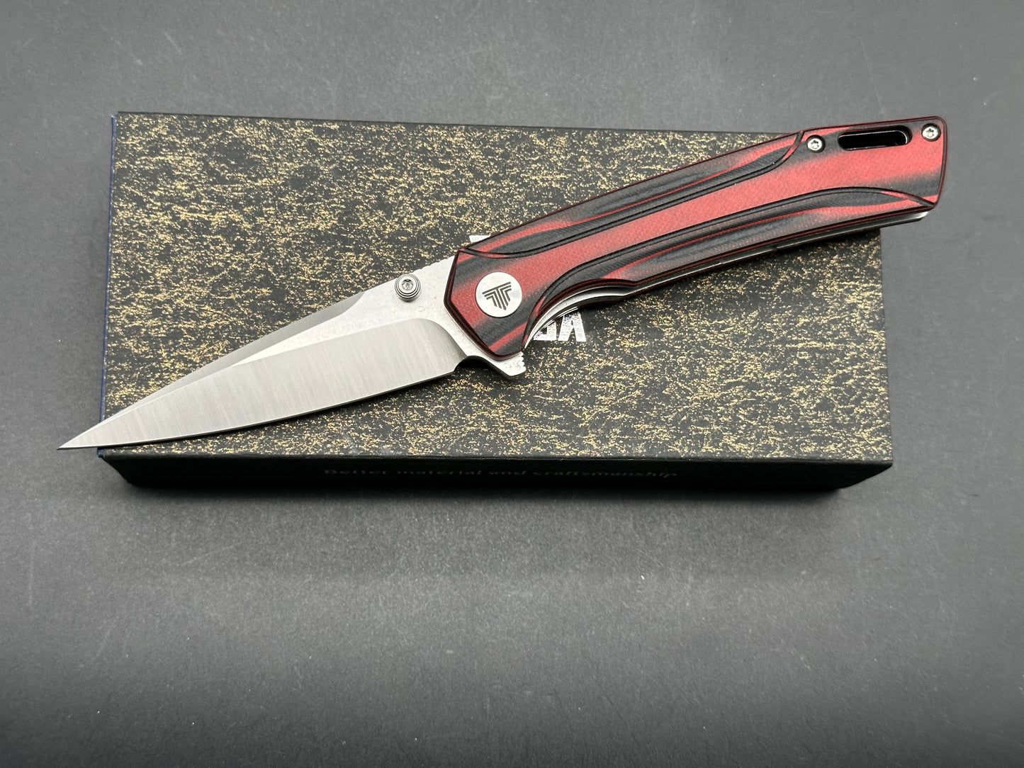 TRIVISA VOLANS-03RB FOLDING KNIFE RED/BLACK G10 HANDLE 154CM PLAIN EDGE STONEWASH/SATIN FINISH