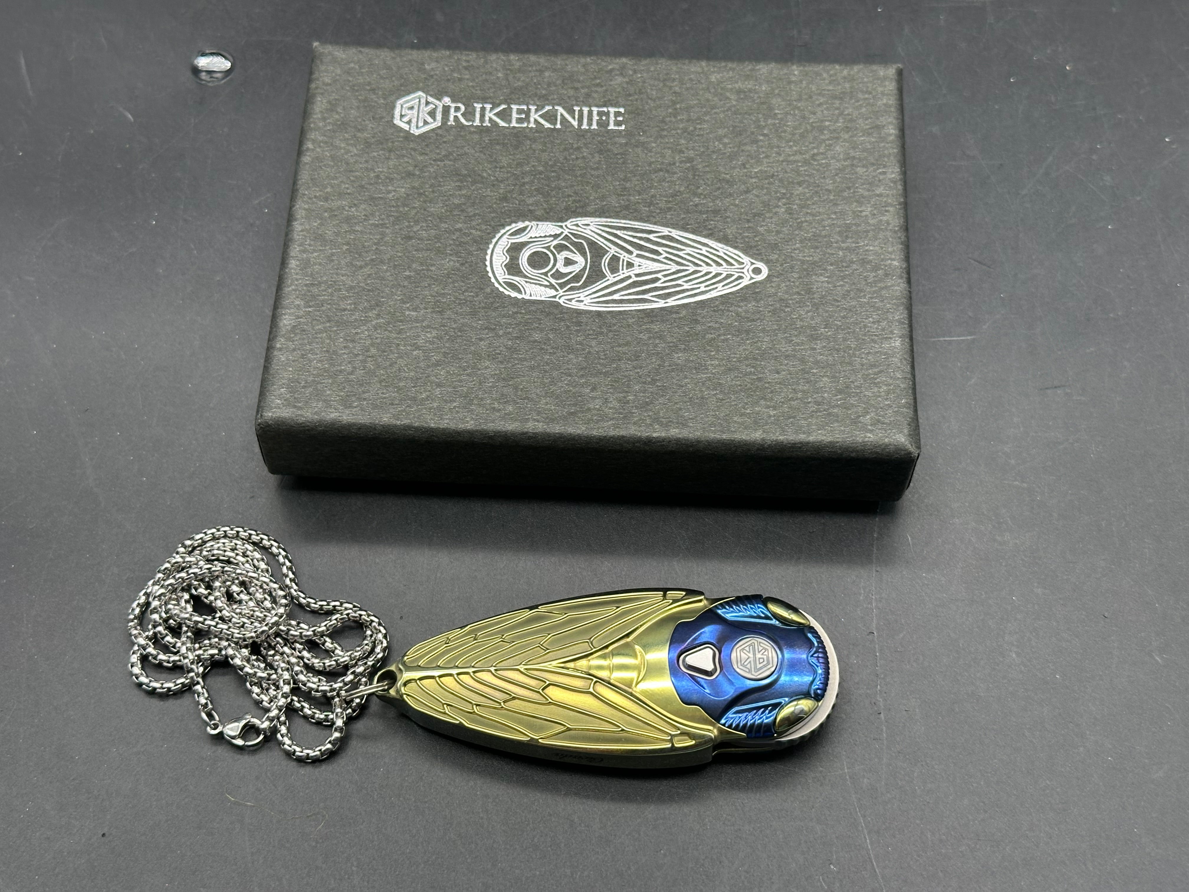 Rike Knife - Cicada Blue & Gold M390 button lock