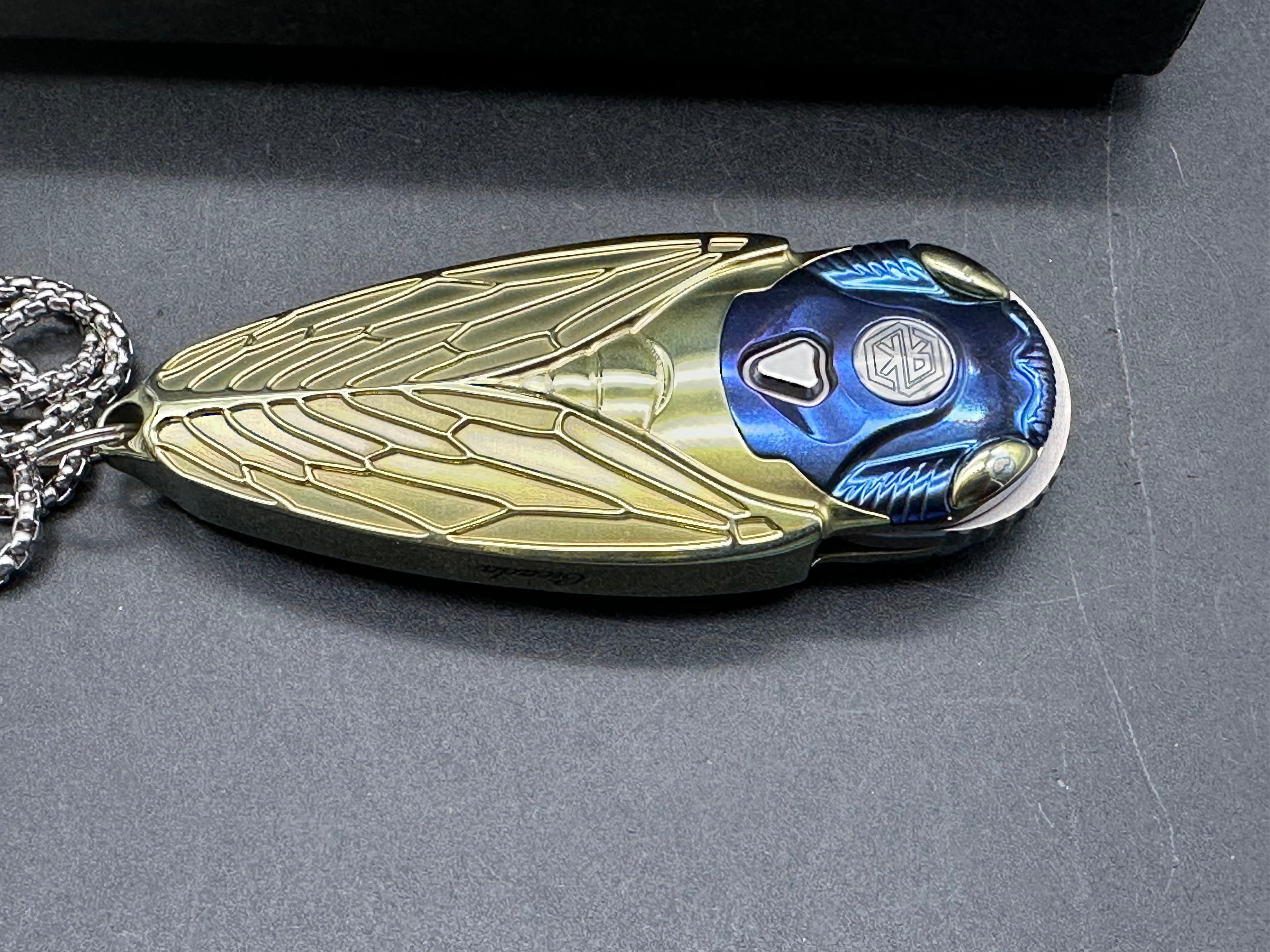 Rike Knife - Cicada Blue & Gold M390 button lock
