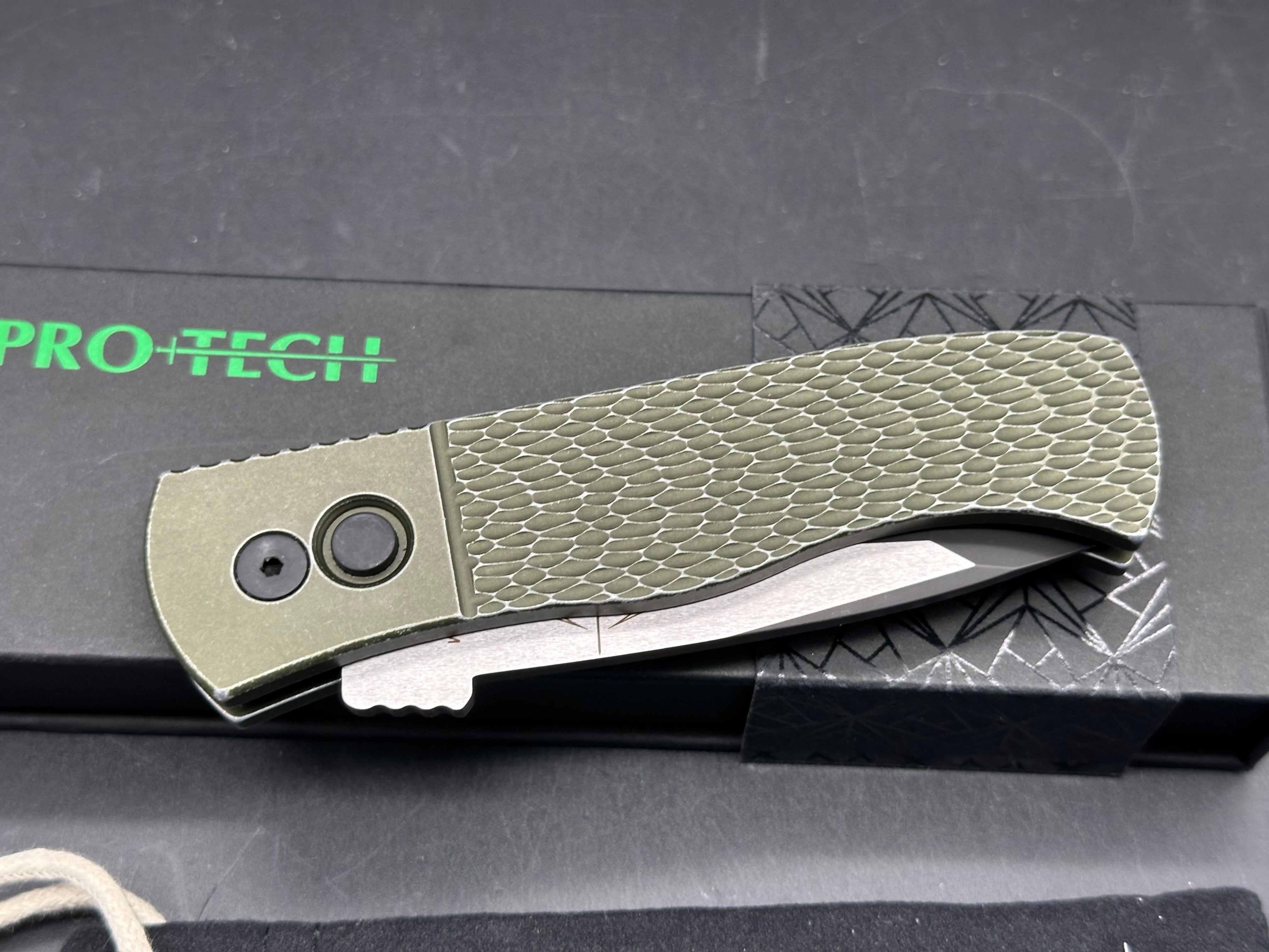 ProTech Emerson Auto CQC-7 Green battle worn textured handle with two tone black/satin blade