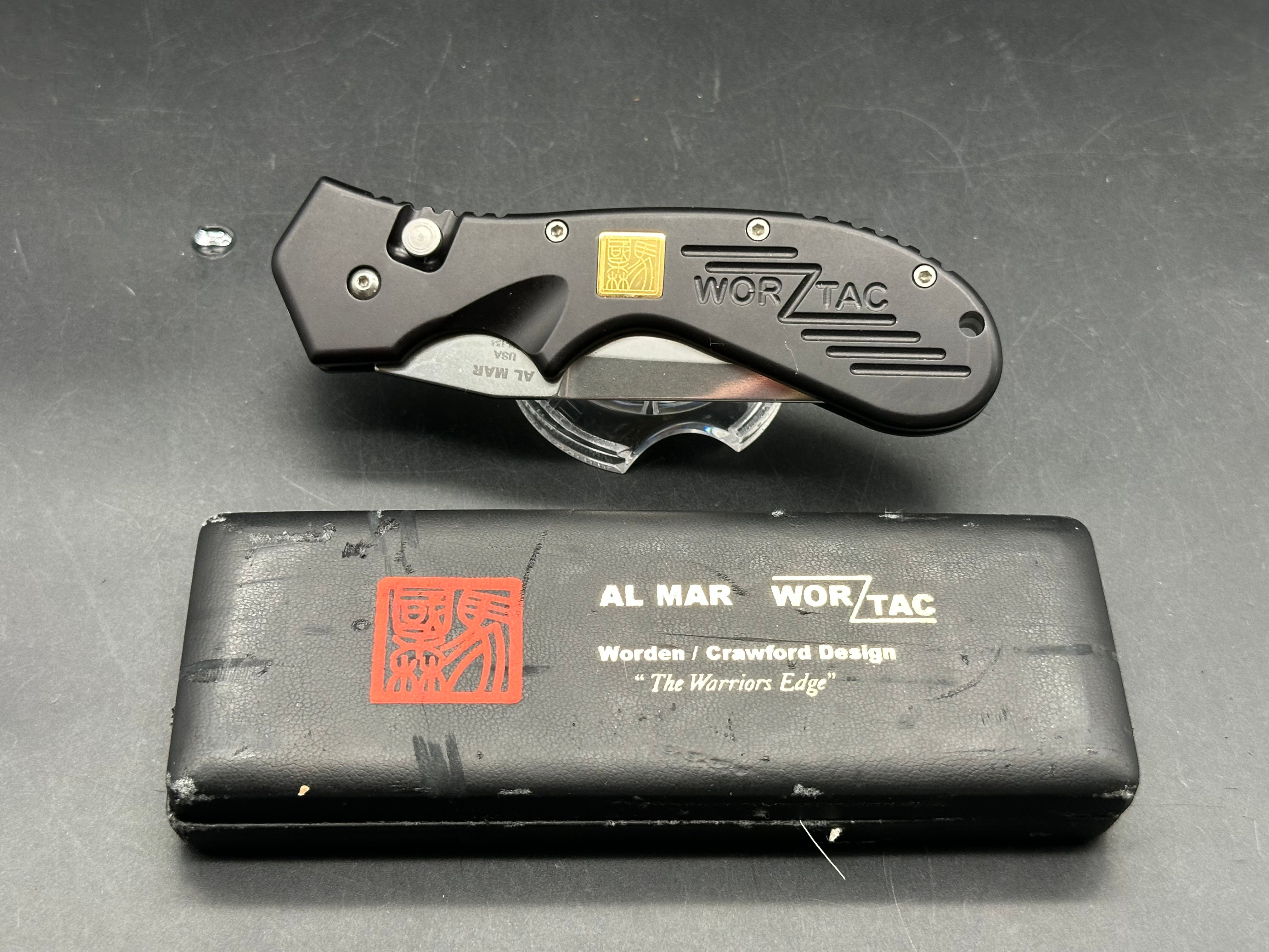 Al Mar Wor-Tac Auto knife was designed by Kelly Wordon and Pat  Crawford