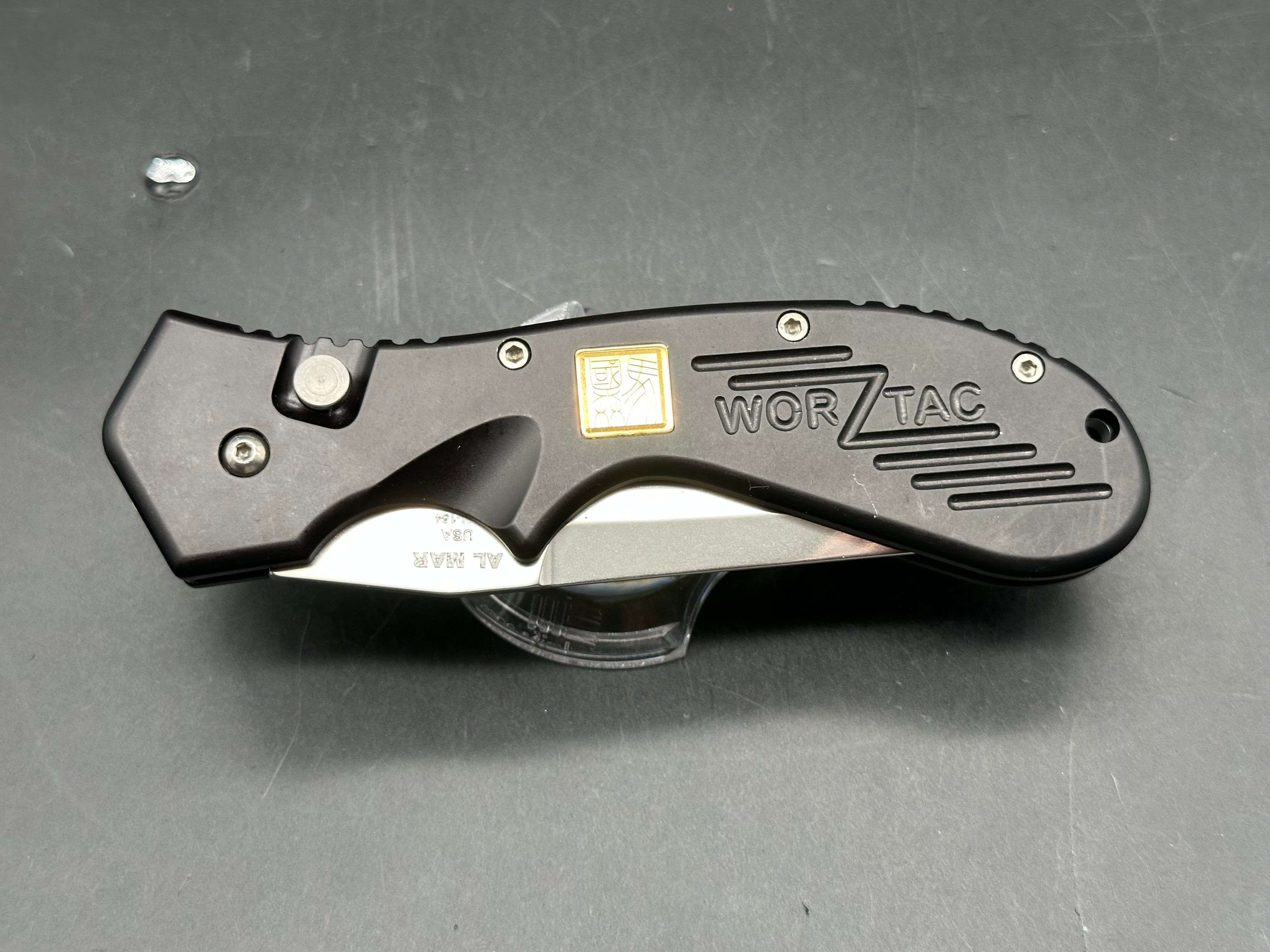 Al Mar Wor-Tac Auto knife was designed by Kelly Wordon and Pat  Crawford