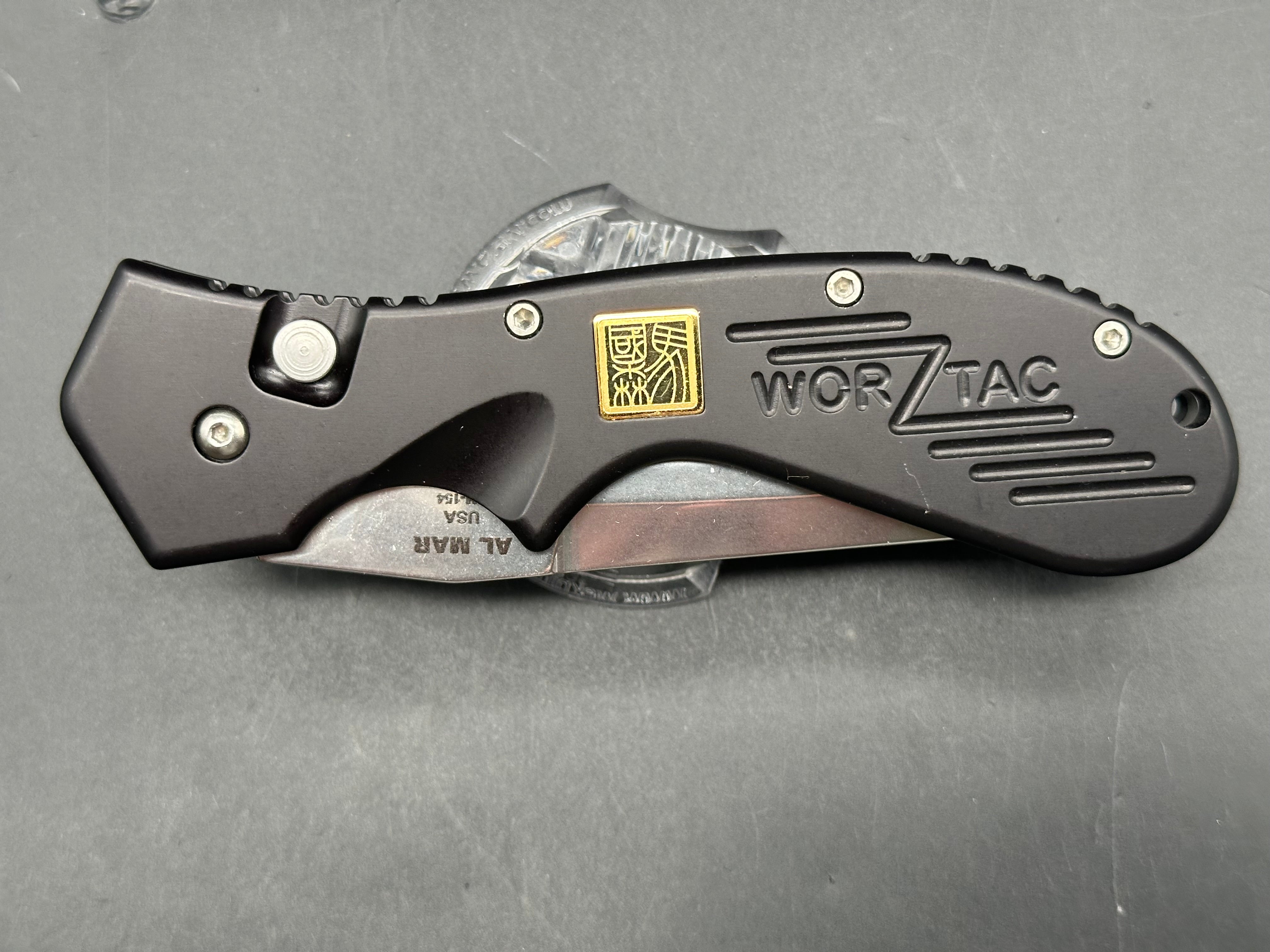 Al Mar Wor-Tac Auto knife was designed by Kelly Wordon and Pat  Crawford