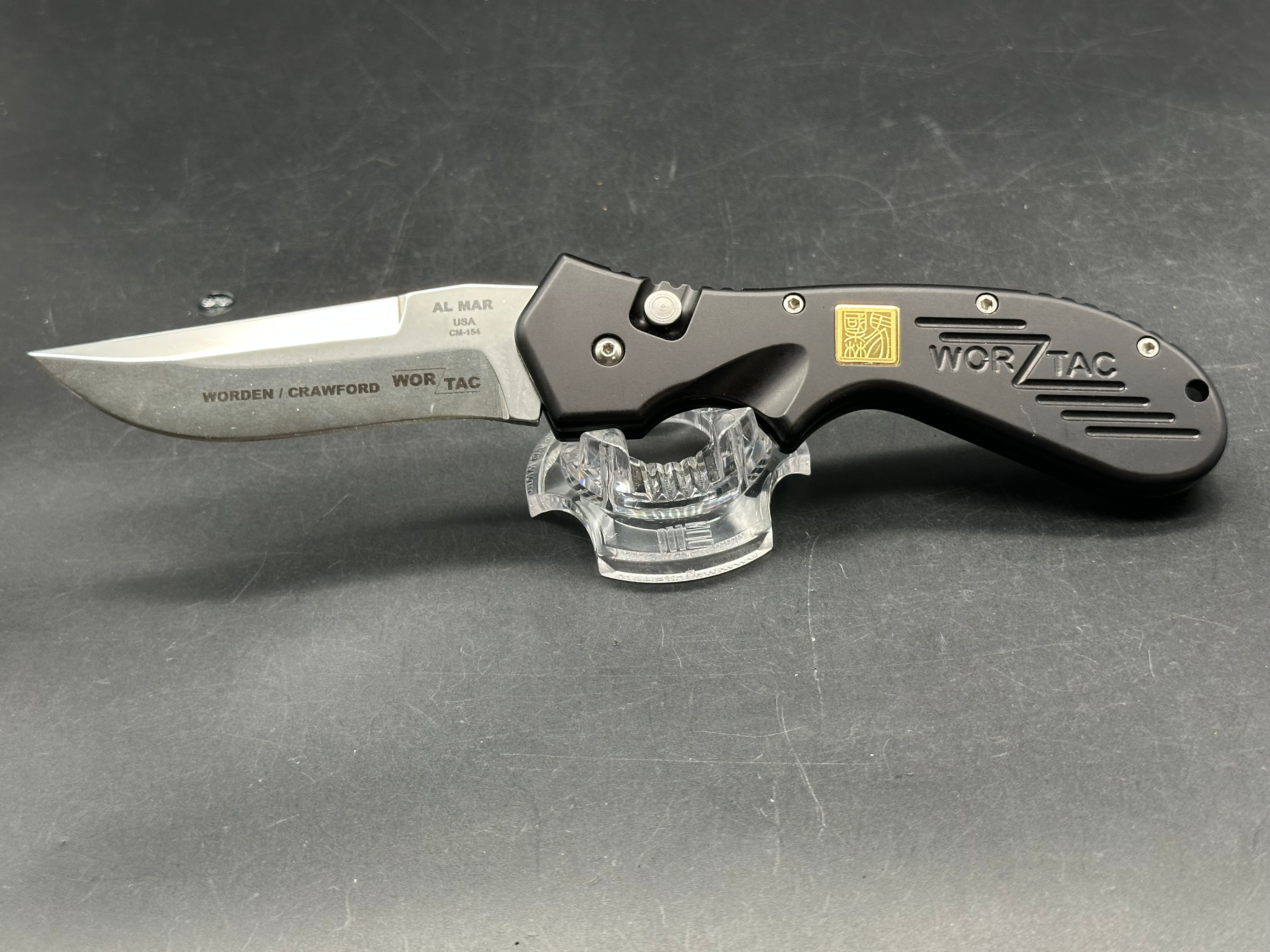 Al Mar Wor-Tac Auto knife was designed by Kelly Wordon and Pat  Crawford