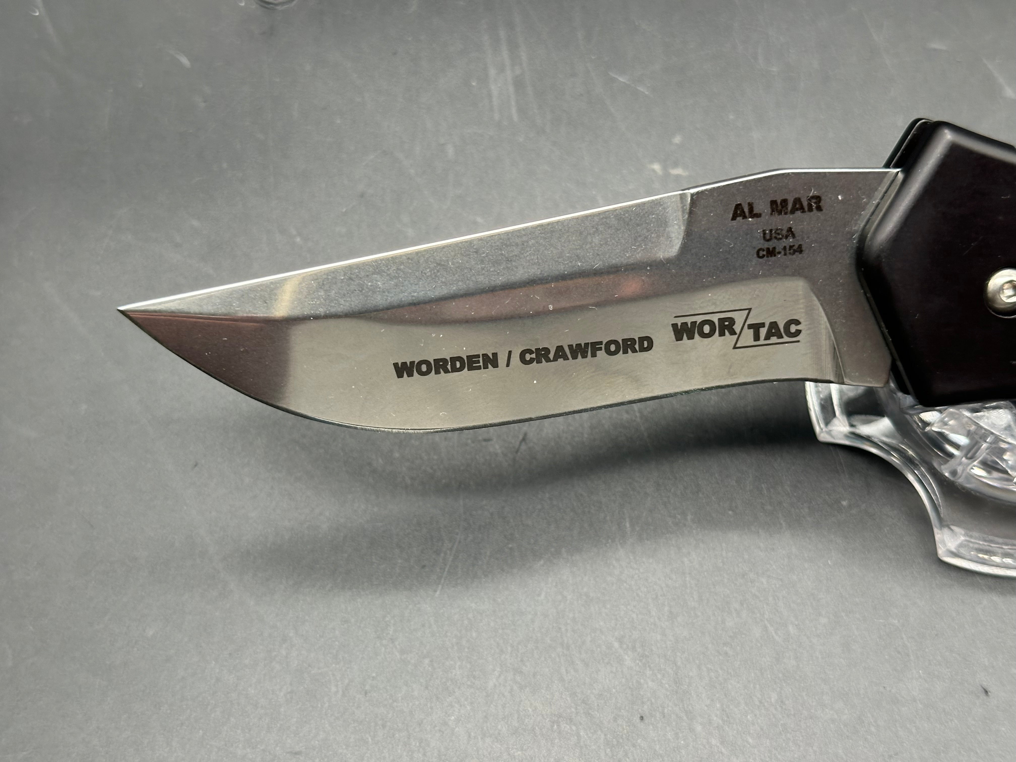 Al Mar Wor-Tac Auto knife was designed by Kelly Wordon and Pat  Crawford