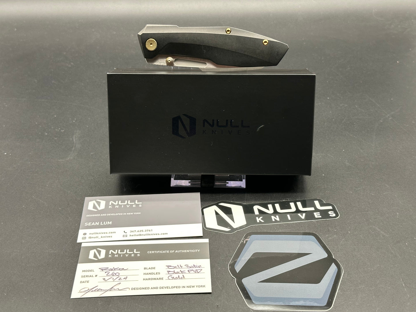 Null Knives Raikou w/black PVD titanium scales with gold hardware and a satin finished S90V blade