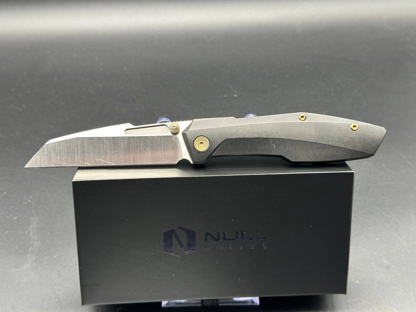 Null Knives Raikou w/black PVD titanium scales with gold hardware and a satin finished S90V blade