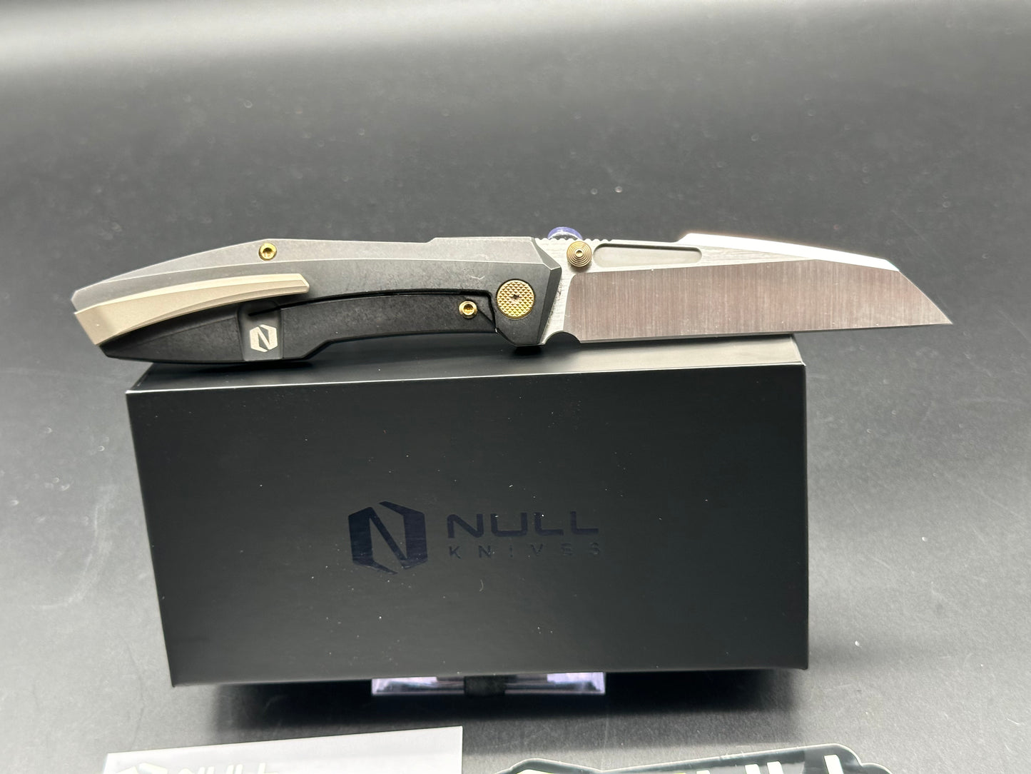 Null Knives Raikou w/black PVD titanium scales with gold hardware and a satin finished S90V blade