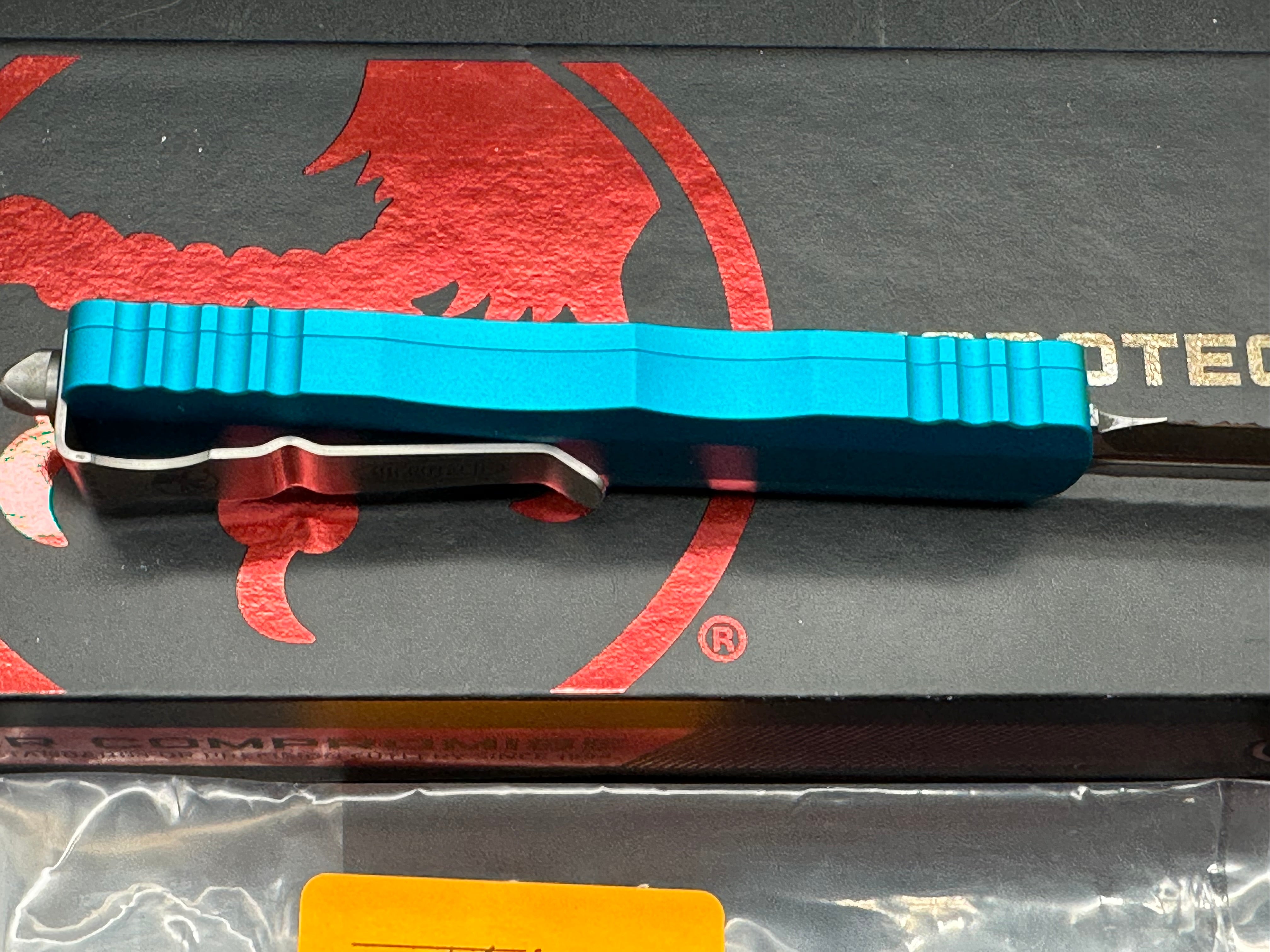 Microtech 225-11TQ Dirac AUTO OTF Knife 2.92" Stonewashed Double Combo Edge Dagger Blade, Turquoise Aluminum Handles