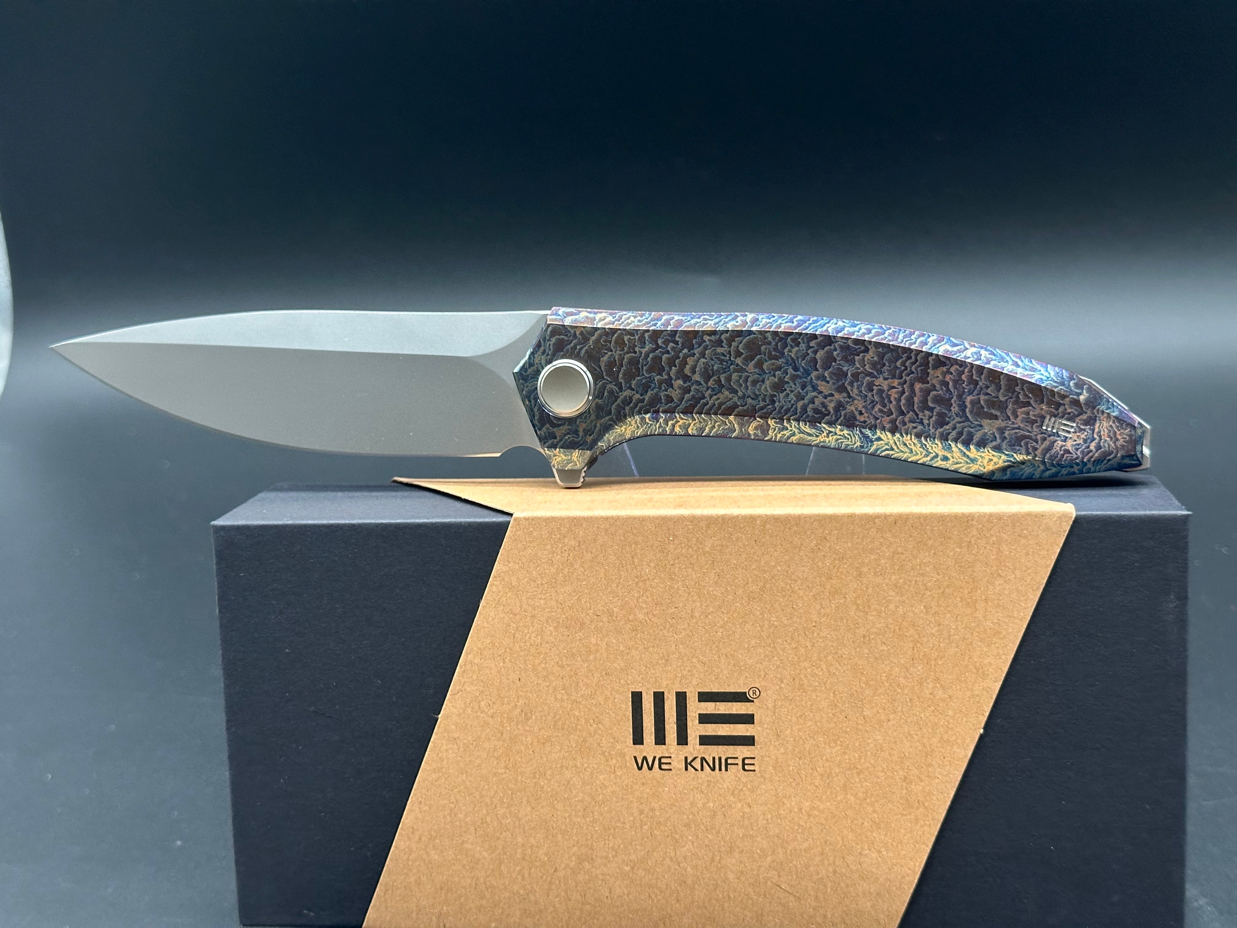 WE ACUMINAL FOLDING KNIFE FLAMED TITANIUM HANDLE VANAX PLAIN EDGE POLISHED BEAD BLAST FINISH