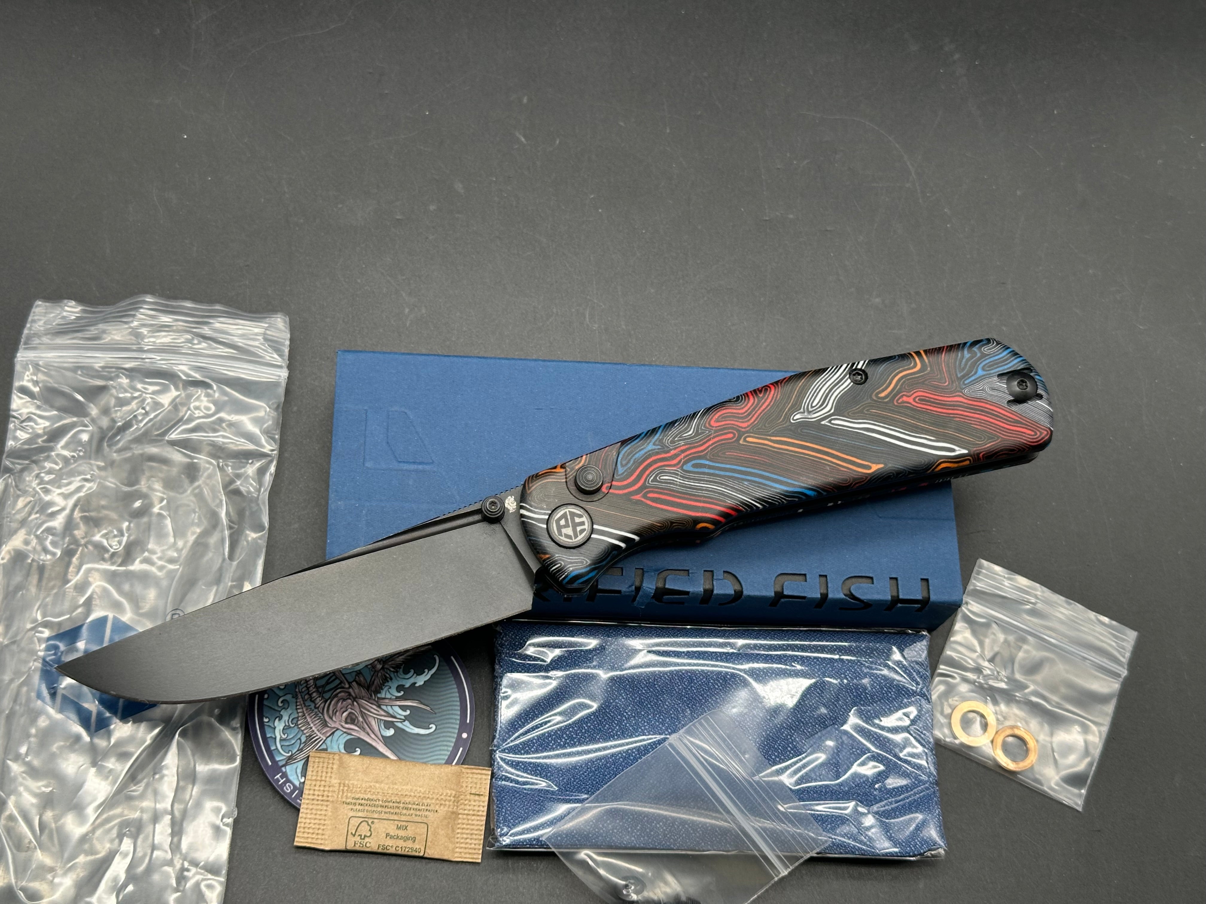 PETRIFIED FISH LIS FOLDING KNIFE BUTTON MULTI COLOR HANDLE 10CR15COMOV BLACK BLADE