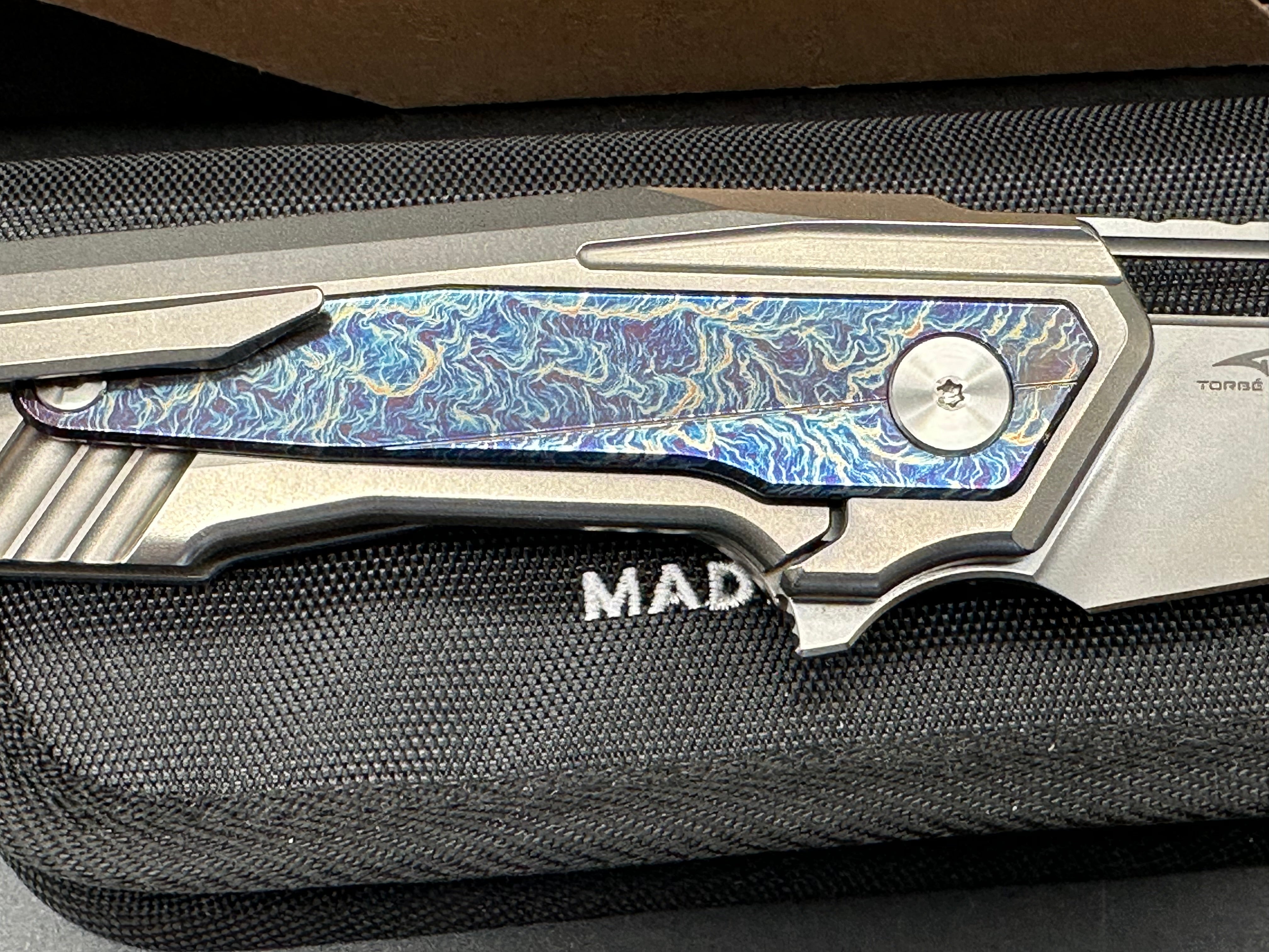 We Knives Maciej Torbe Falcaria Titanium Handle Lightning Ano Inlays CPM-20CV